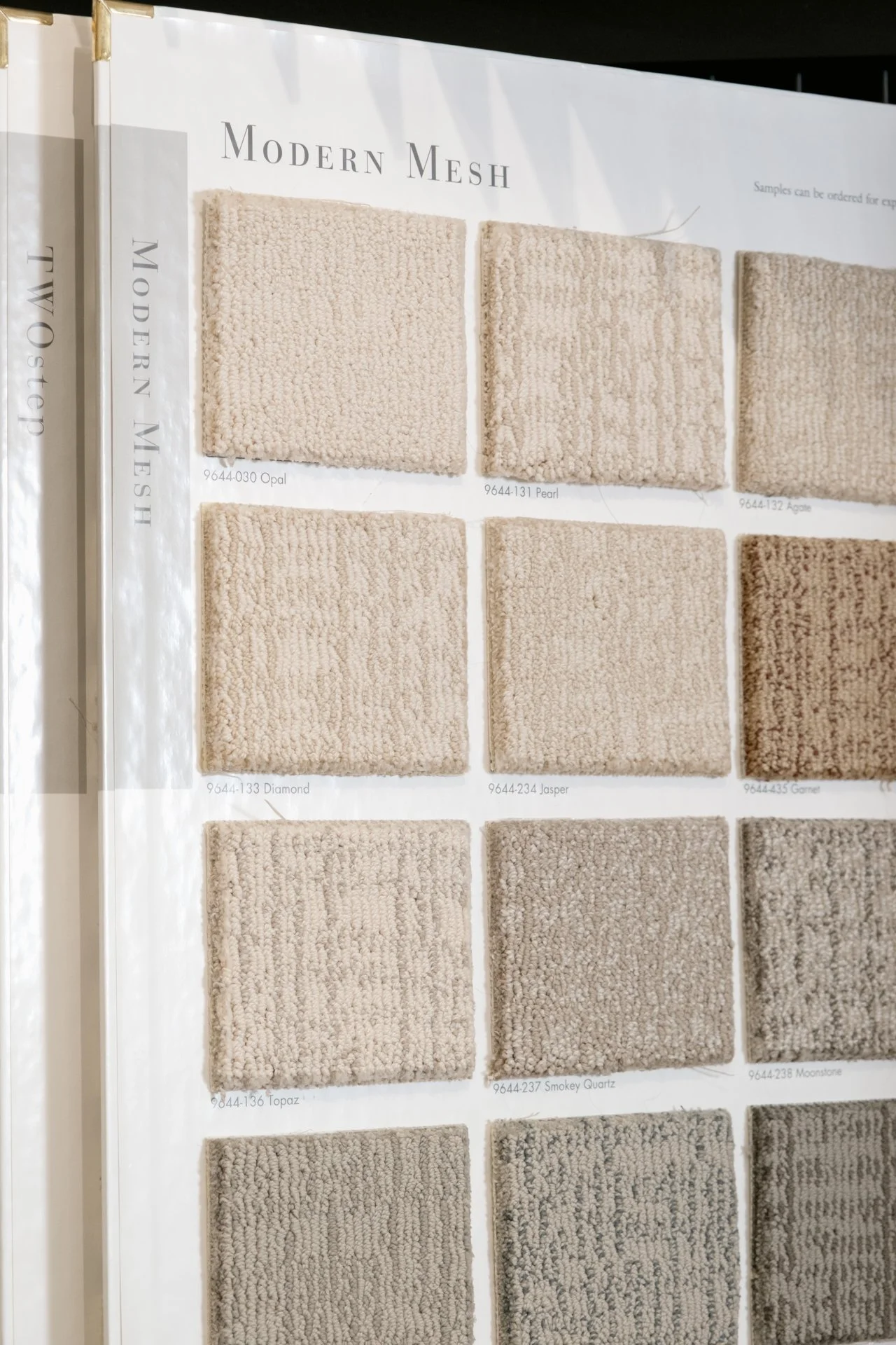 A display of beige and neutral-colored carpet samples labeled under the heading 'Modern Mesh'.