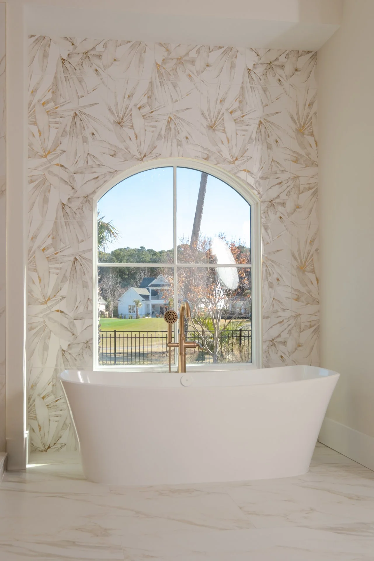 Master bathroom with a white tub, a floor-to-ceiling focal wall in a Val Revesta Felci Deco tile.