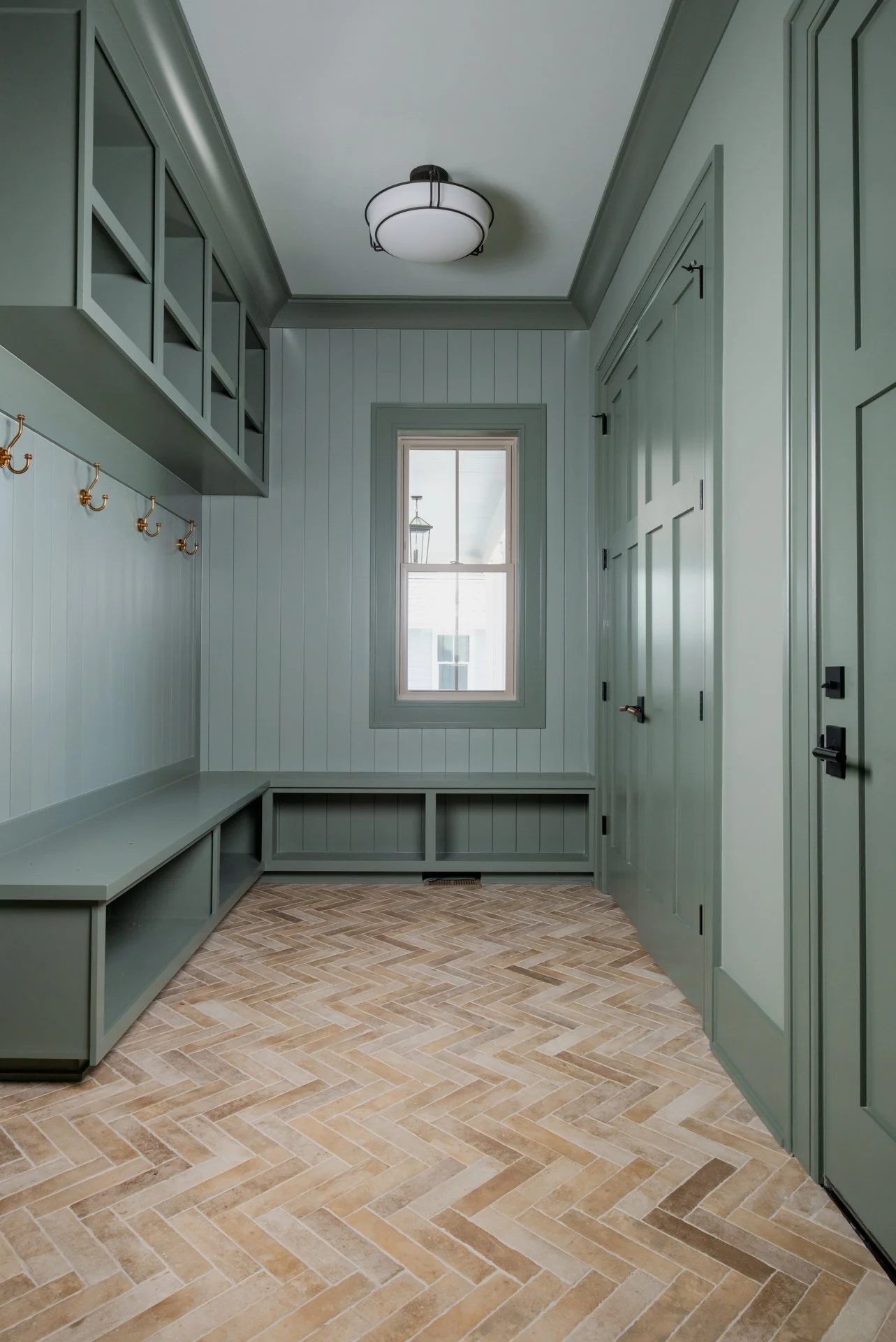 A drop zone + laundry spaces, with Bedrosians Tile Montana 2.25"x10" matte brick-look porcelain in Flathead — a product that brings together durability, texture, and timeless character in all the right ways. These hardworking areas deserved materials