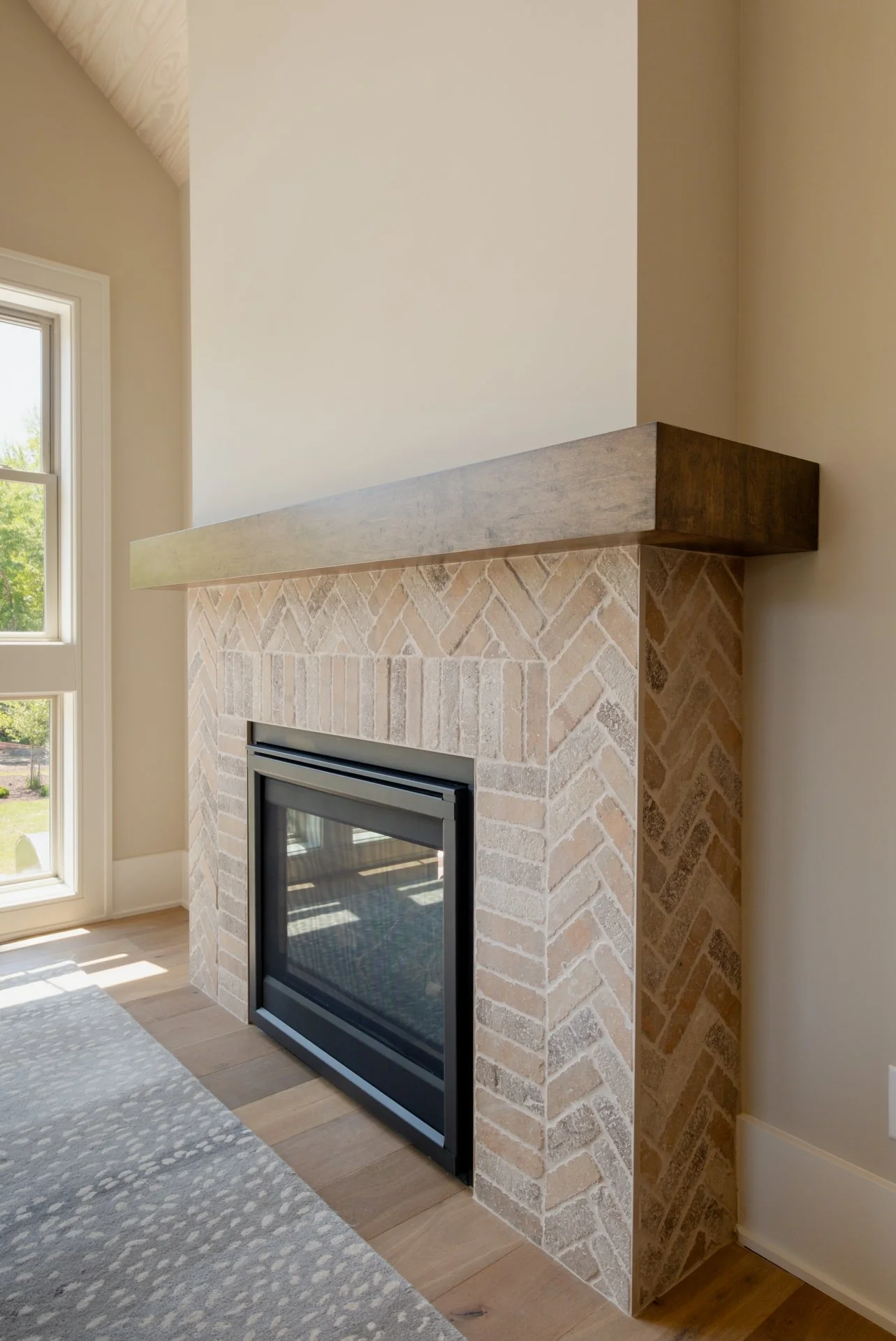 General Shale brick product surrounding a fireplace in a dining room with a dark wood mantle and natural light shining in.
