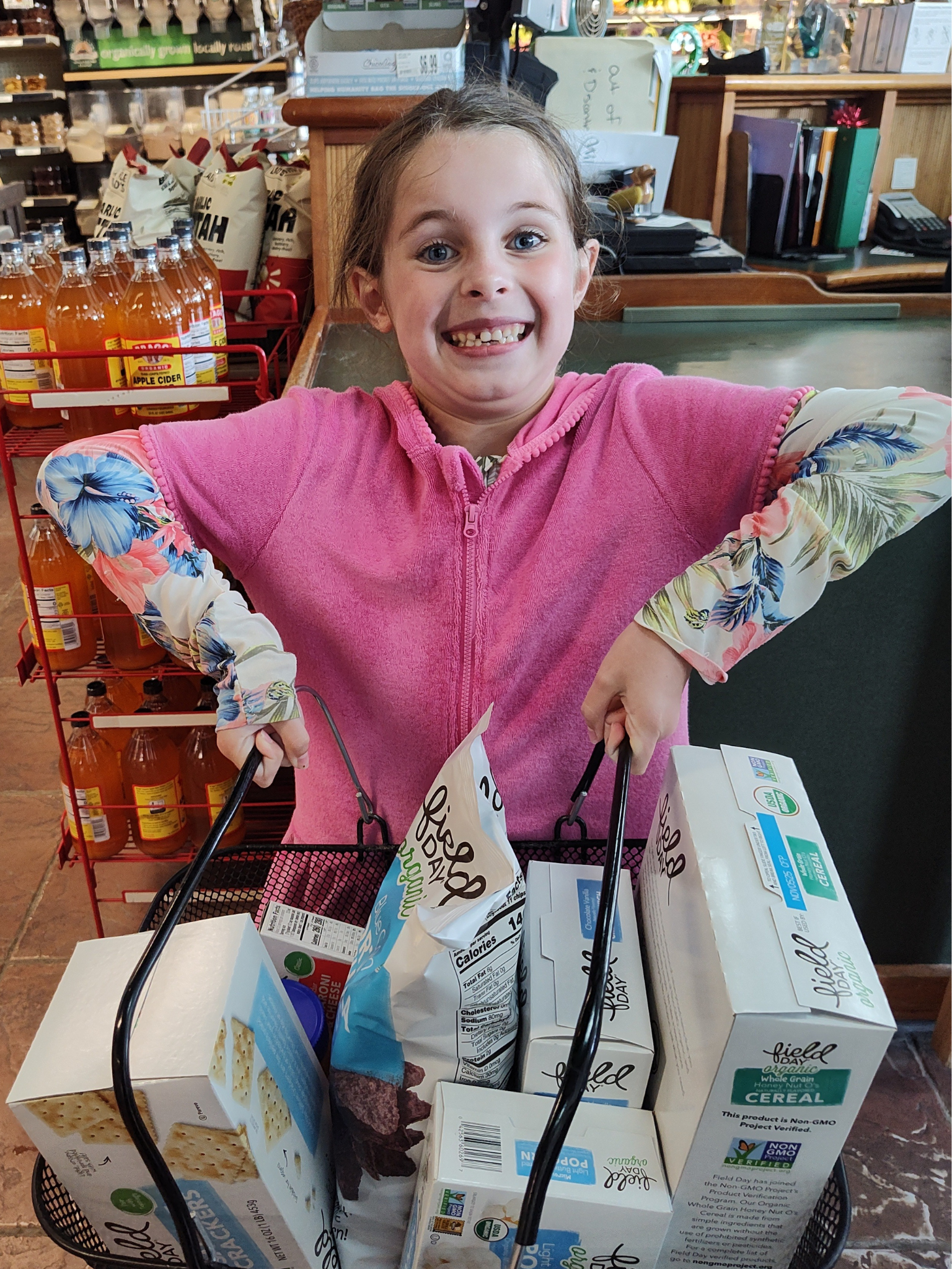 Maryam at checkout at Wild Oats Market with her Field Day organic prize goodies