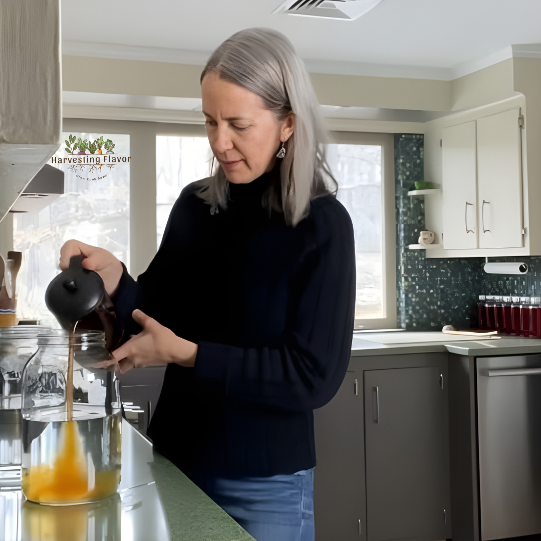 Jill Ahlstrand preparing a fresh plant-based drink in the kitchen