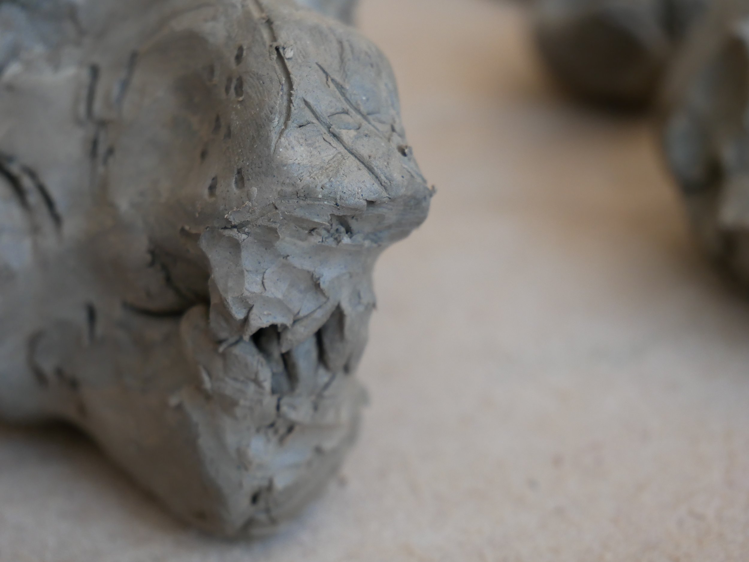  Leslie and Eleni working on clay animal sculptures together in the Venture Arts studio. Leslie is on the left and Eleni is on the right, both working on wooden boards. The photos show the animals in varying places along the journey of becoming full 