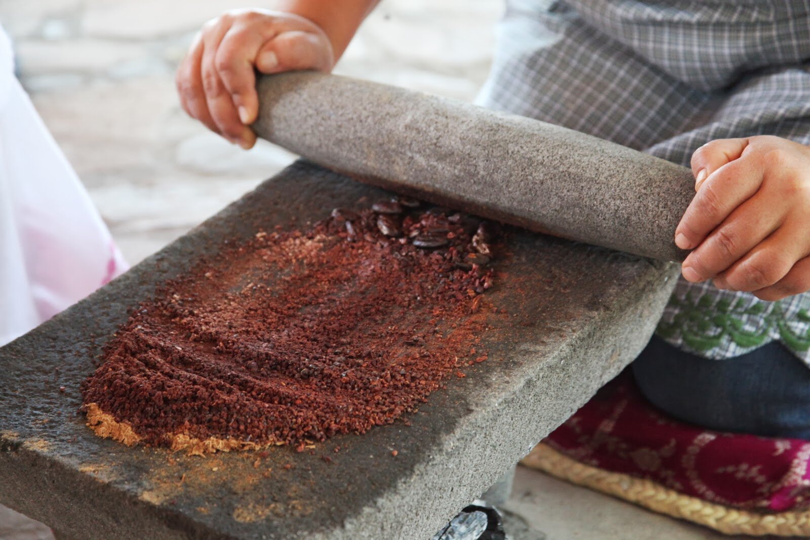 Cacao being stone-ground into paste in Oaxca