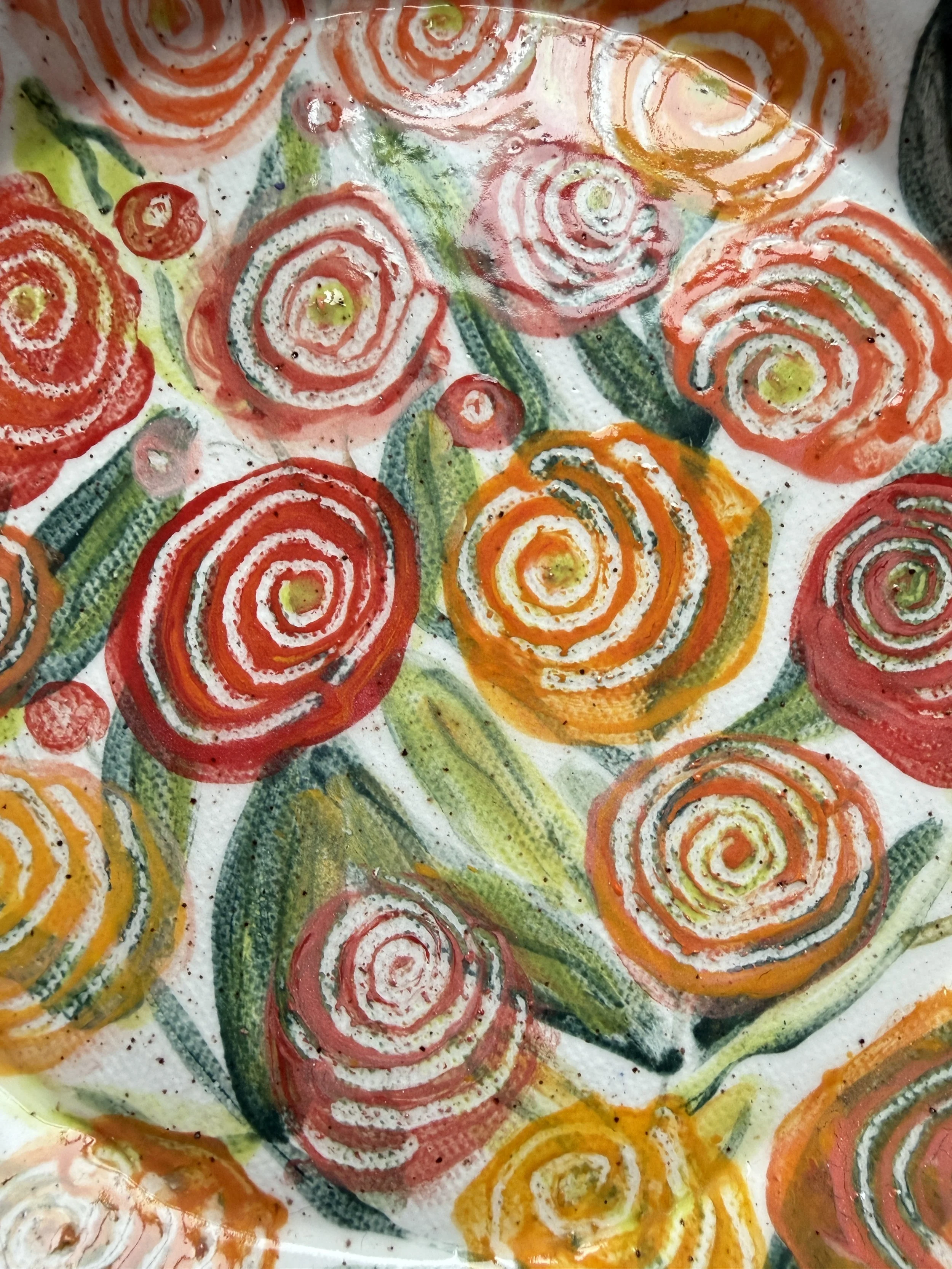 Red and Orange Ranunculus Flowers on Ceramic Plate