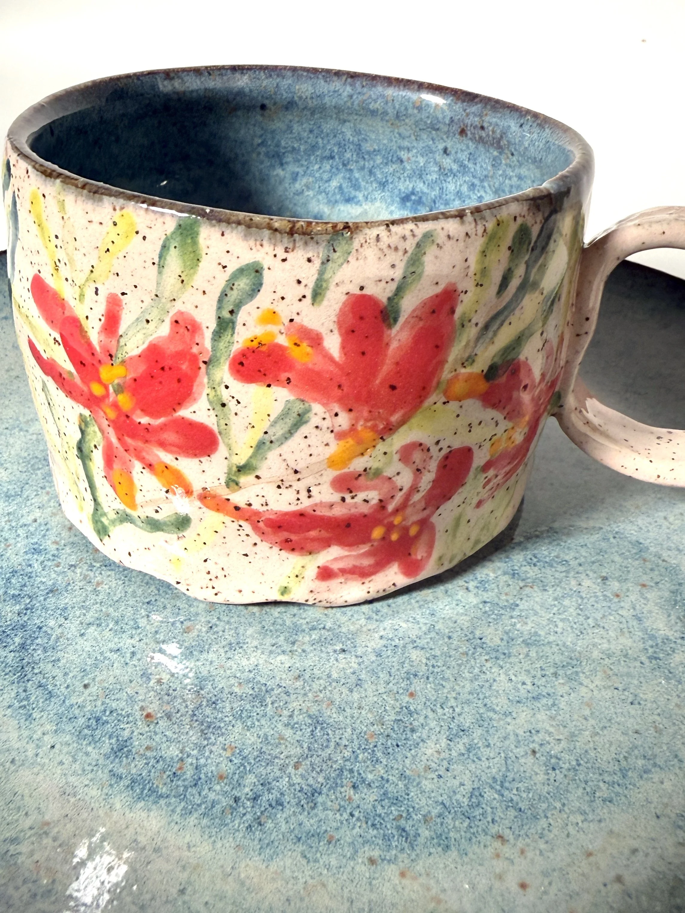 Closeup of handmade ceramic tropical orchid mug