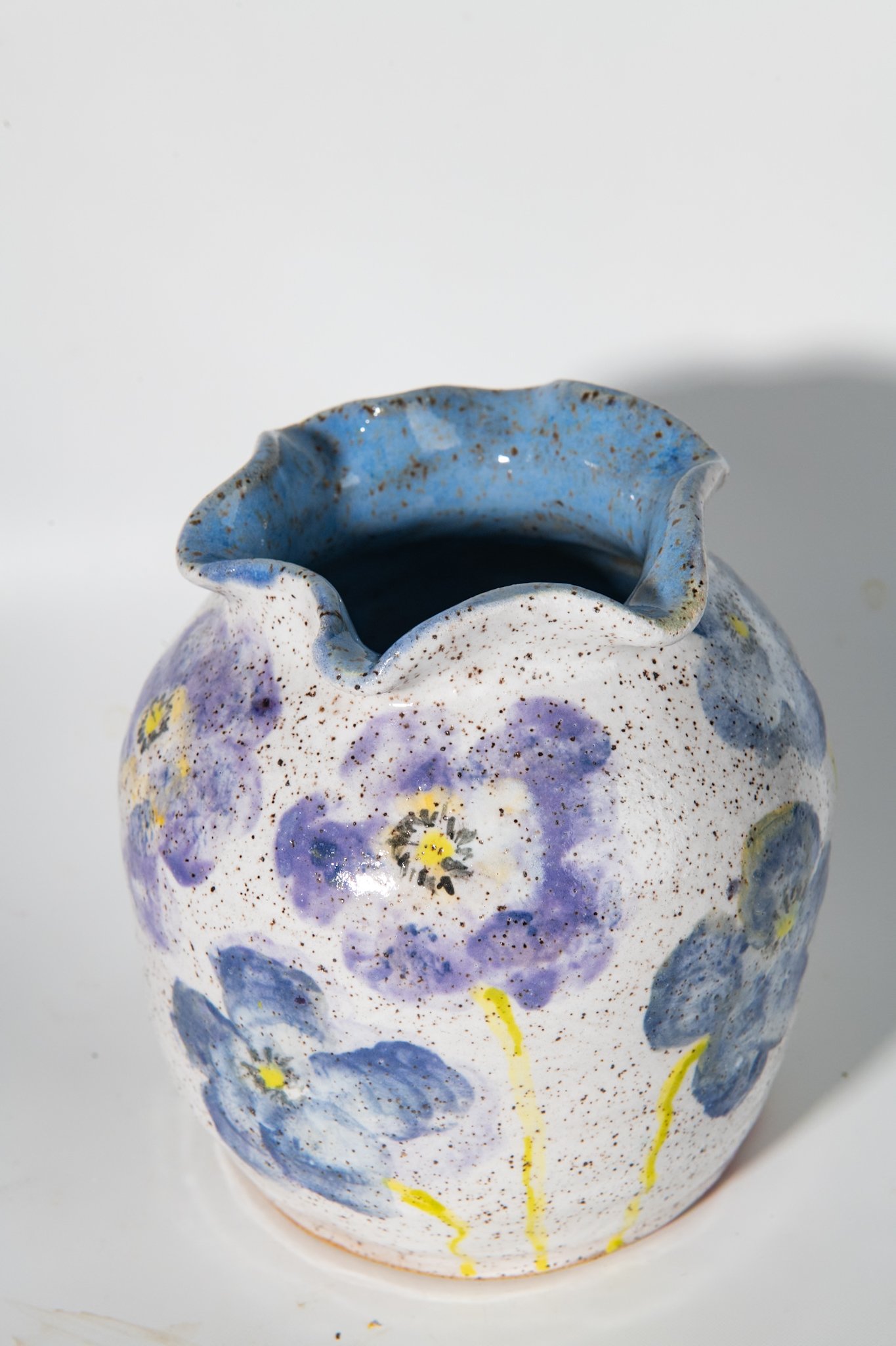 closeup of purple poppy vase