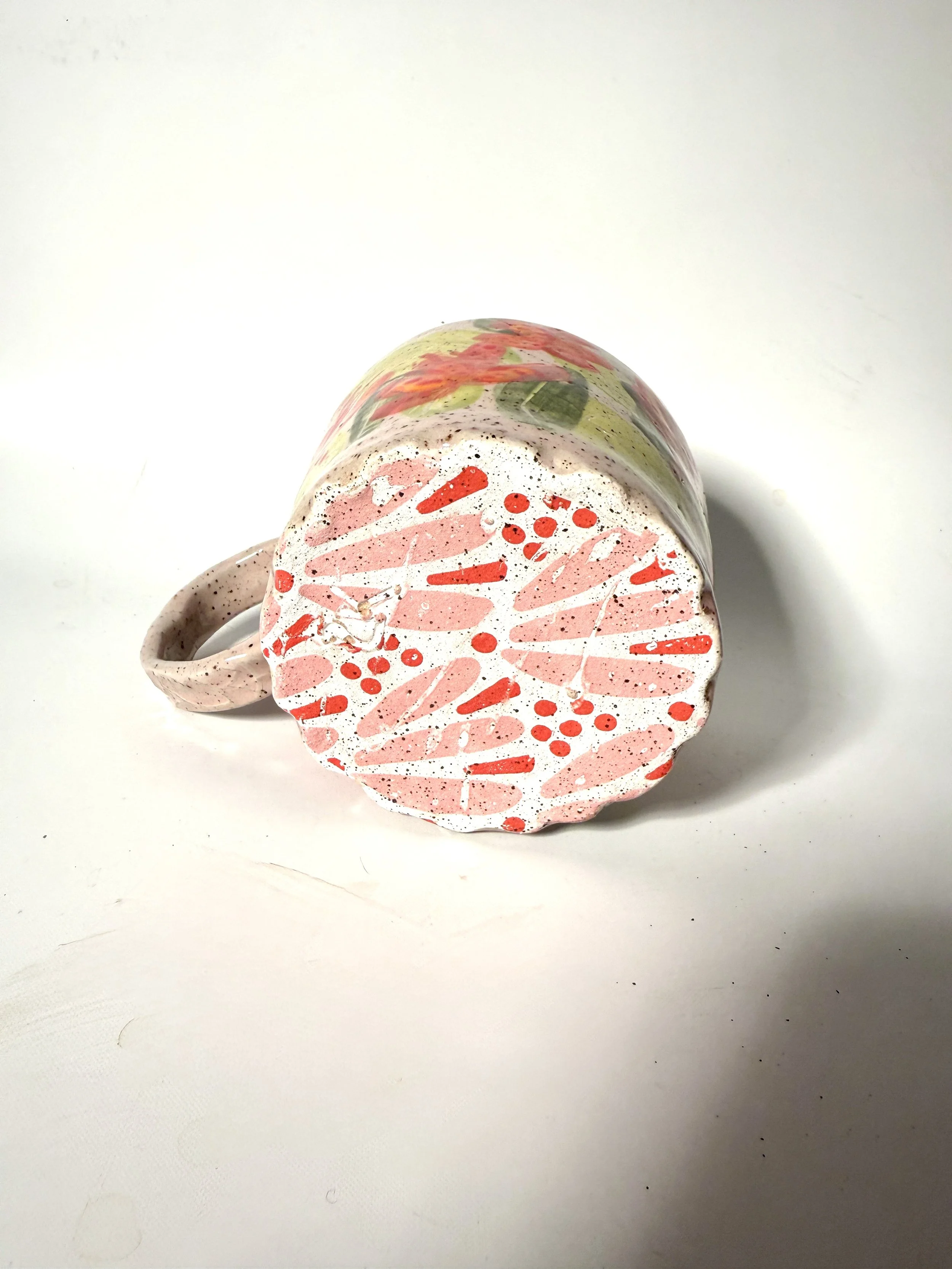 bottom view of the bottom of the handmade ceramic mug with tropical pink orchids