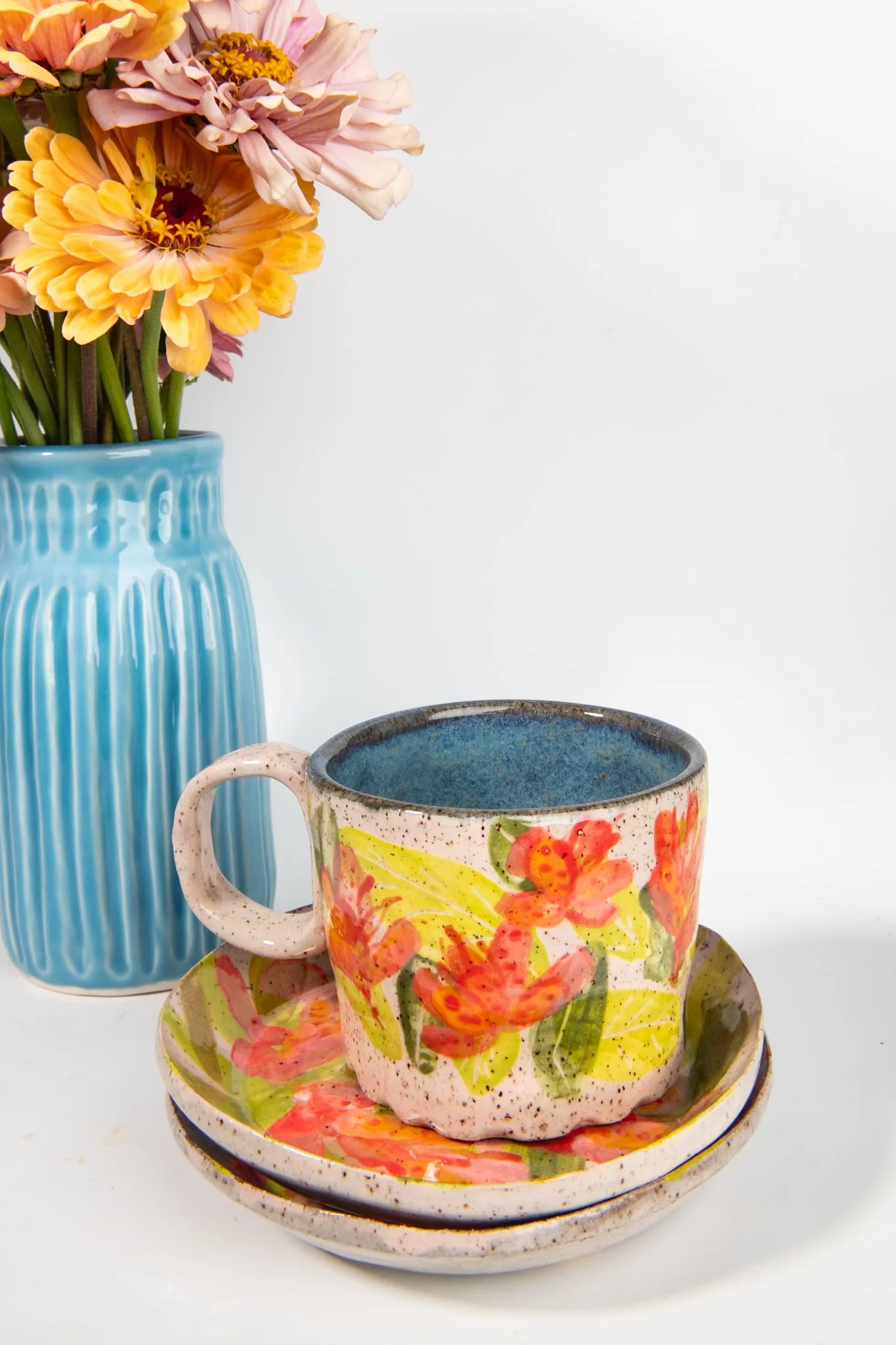 view of tropical pink orchid saucers with matching mug resting on it