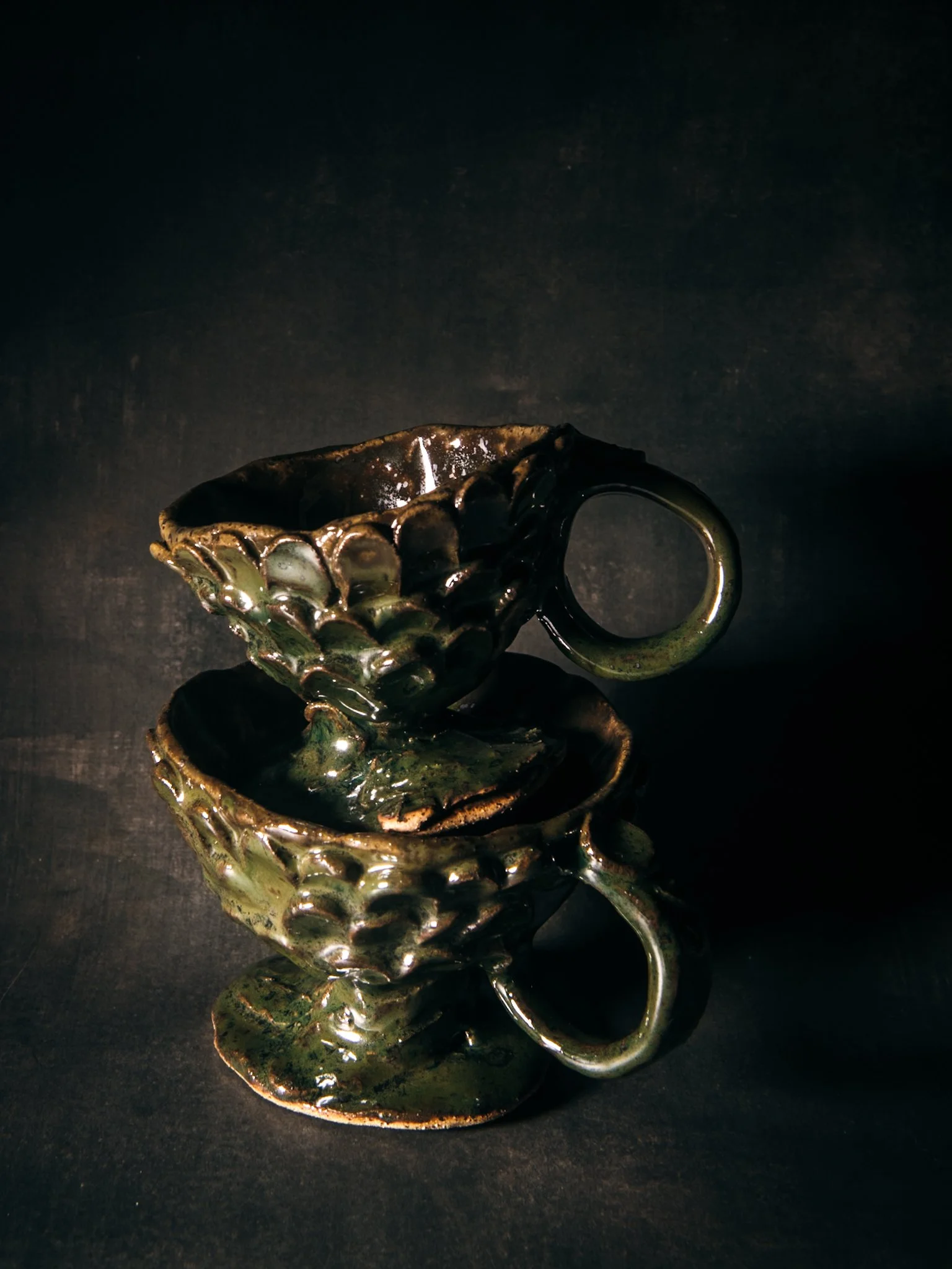 Two whimsical cups in dramatic setting