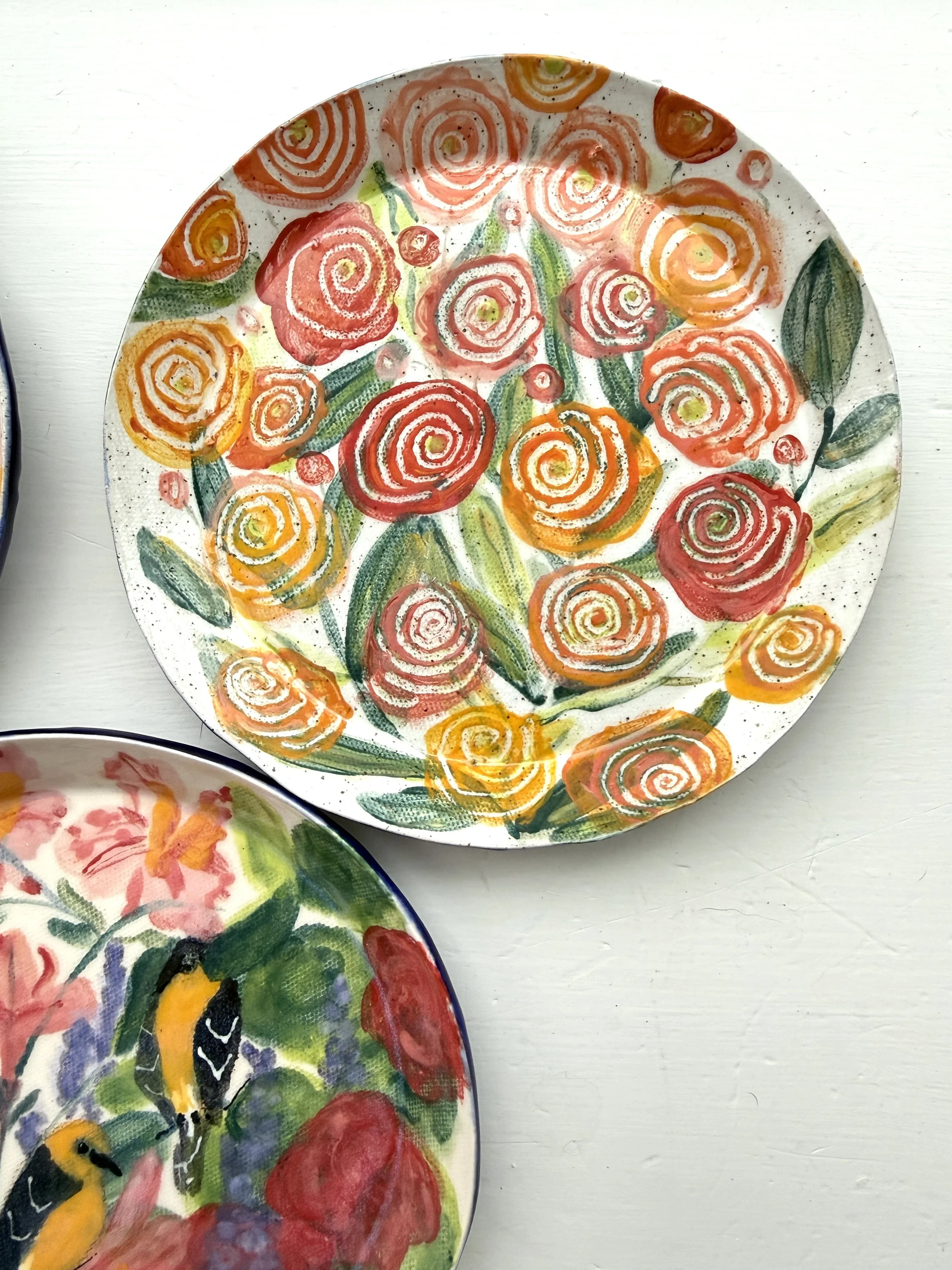 Red and Orange Ranunculus Flowers on Ceramic Plate