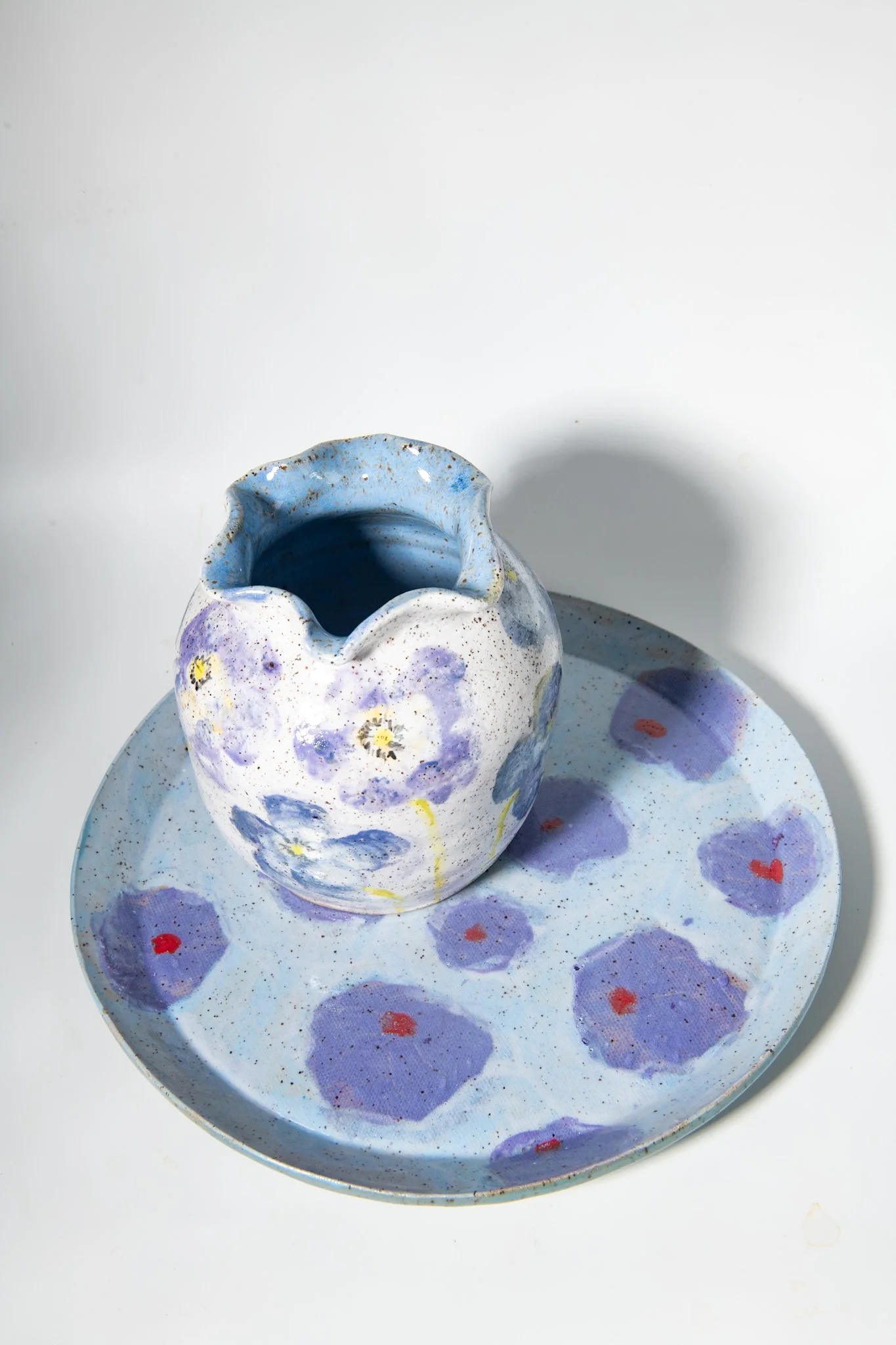 Purple Poppy Ceramic Plate on Blue Background