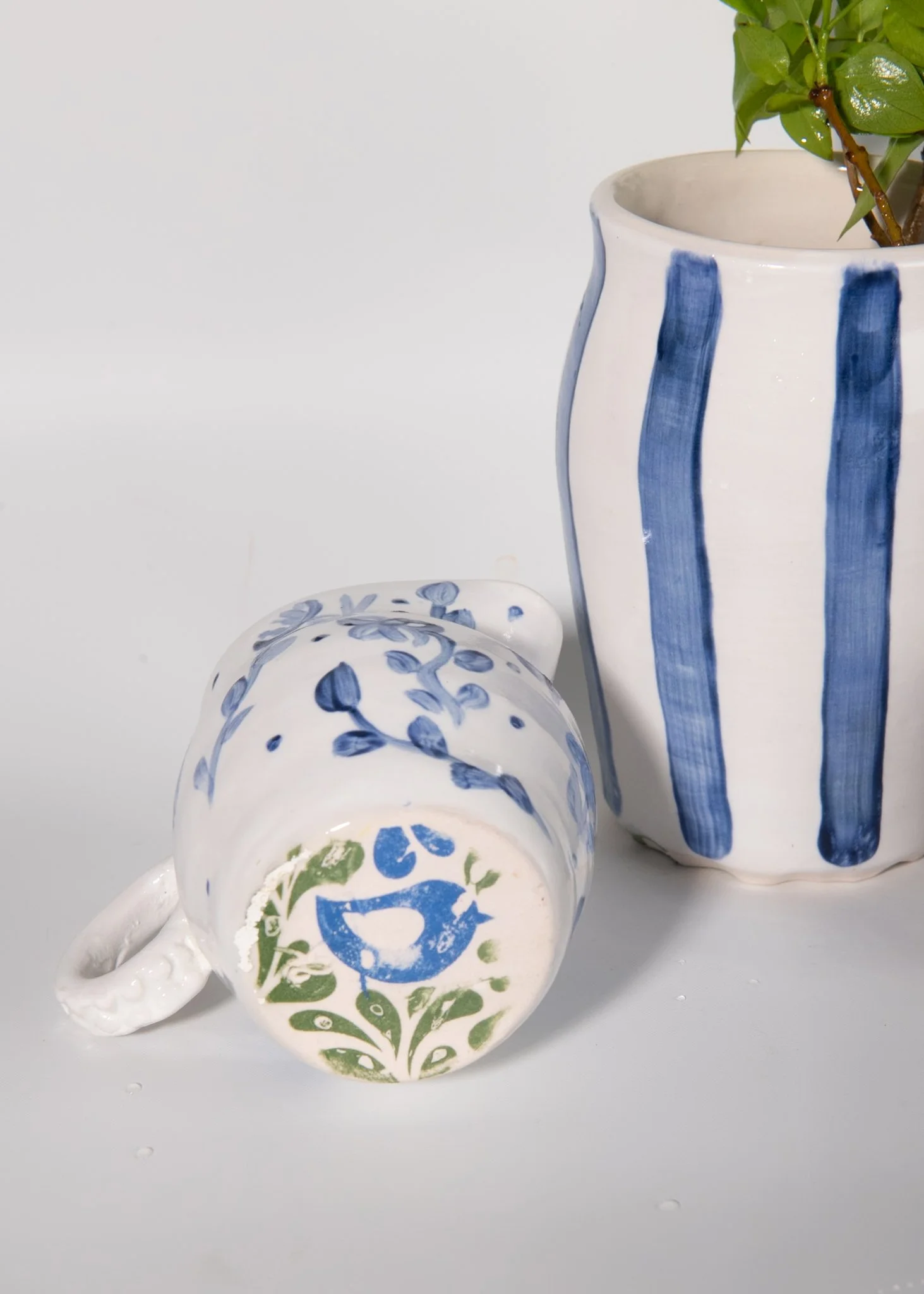 Bottom view of handmade porcelain small pitchers with bluebird design