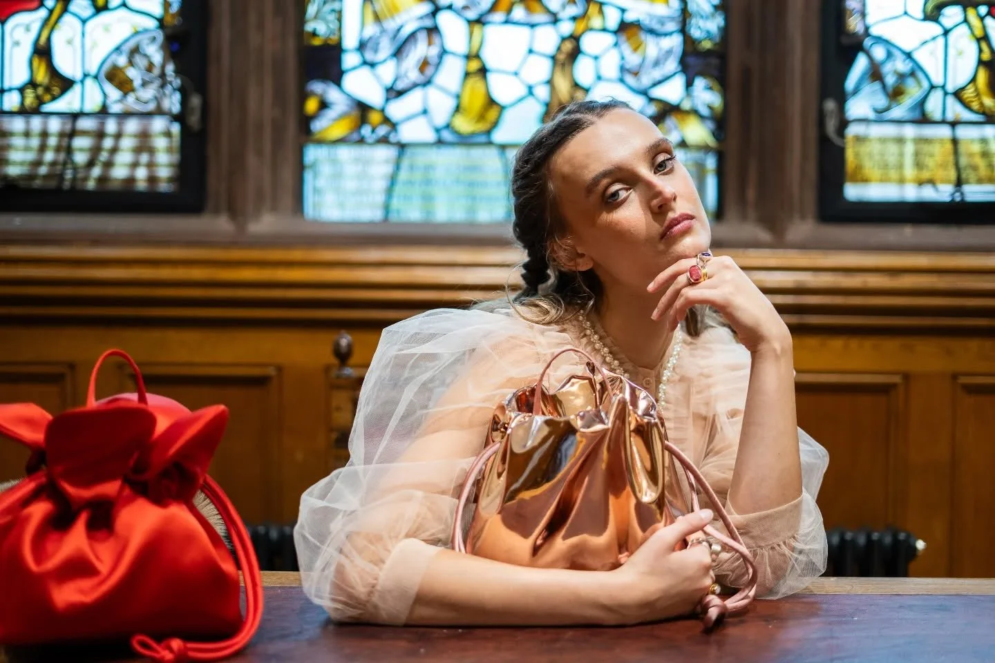The Scrunch  Bag in Mirror Rose Gold - Reflective fabric drawn into soft folds. Hand-covered drawstrings with distinctive knots.
A play of reflection and form — the scrunch, the drawstring, fragments of light.
Worn handheld or crossbody. Both s