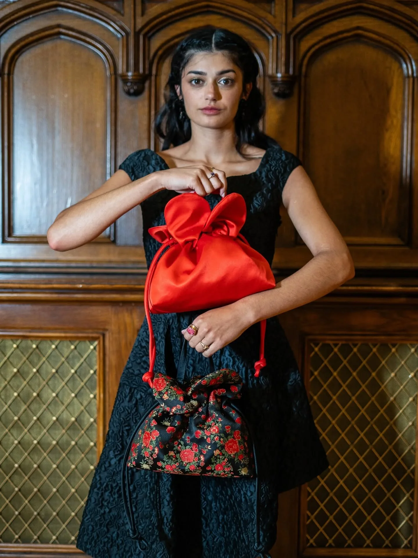 The Petal Cinch in scarlet satin and floral embroidered satin. The newest story in the August Night Collection. It can be worn as a handheld tote but also has an adjustable strap to wear as a shoulder bag or crossbody.  Your newest conversation start