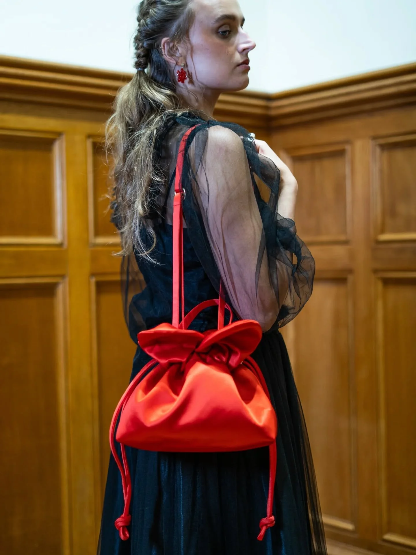 Ways to wear the Petal Cinch bag . Available in scarlet,  black or navy satin.
Silk tulle Skirt @madigan_cashmere 
Earrings @adornbycaoimhe