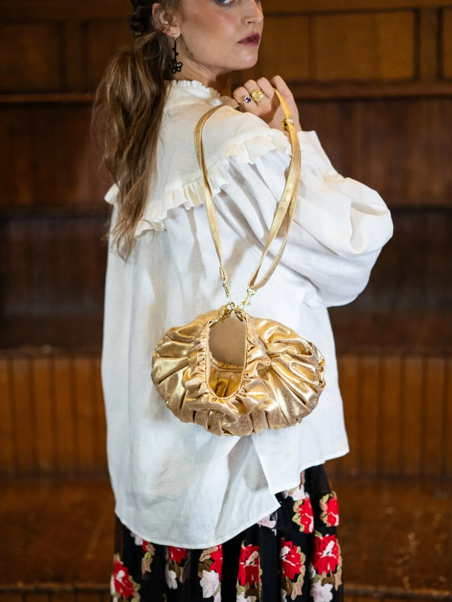The Ruche Clutch in Gilded Gold Cotton, also available in silver..