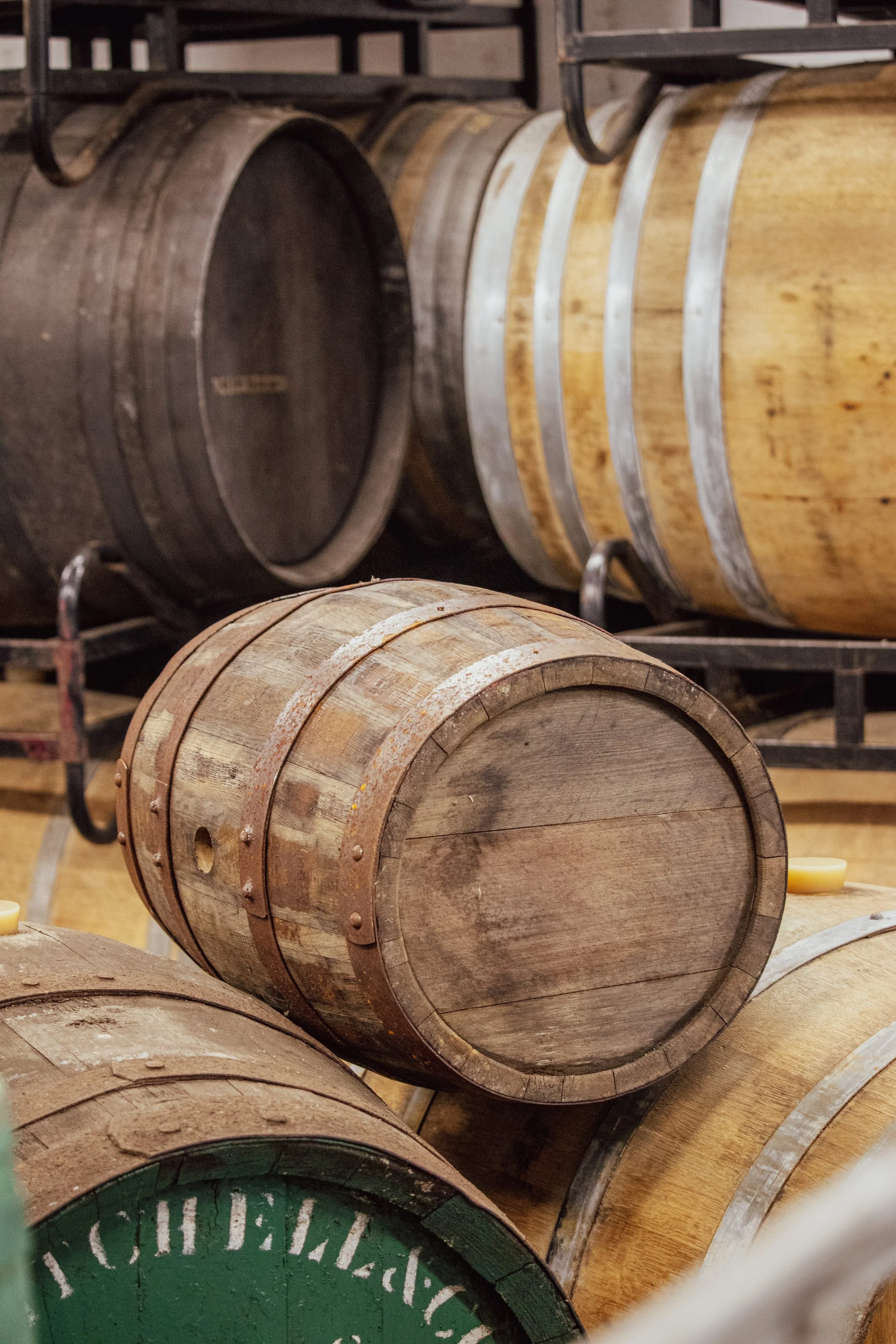 Small whisky cask alongside traditional oak casks (Copy)