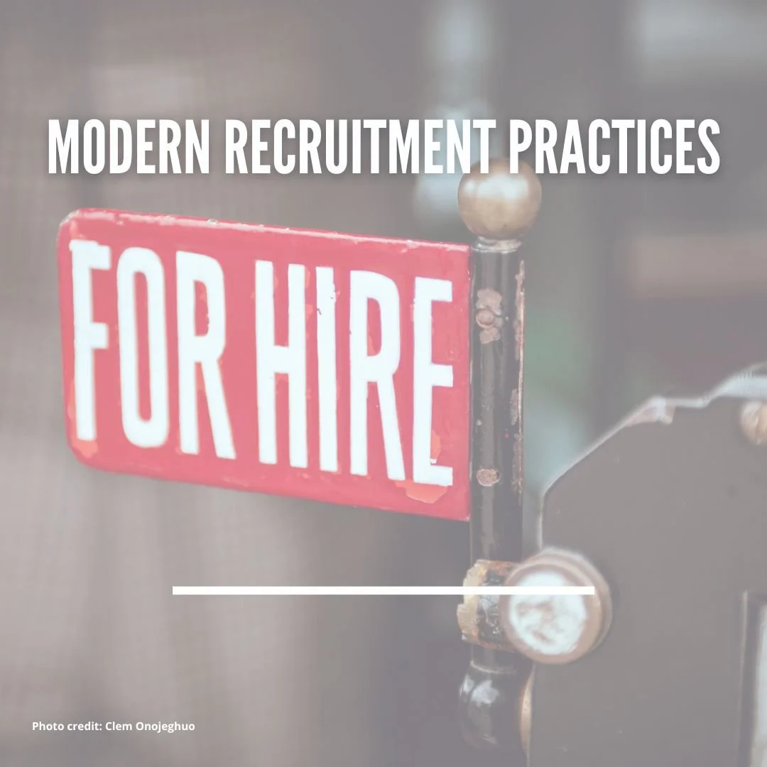 A sign with a red background and white text reading 'FOR HIRE', attached to an antique black and brass door latch. The image has overlaid text that says 'MODERN RECRUITMENT PRACTICES'.