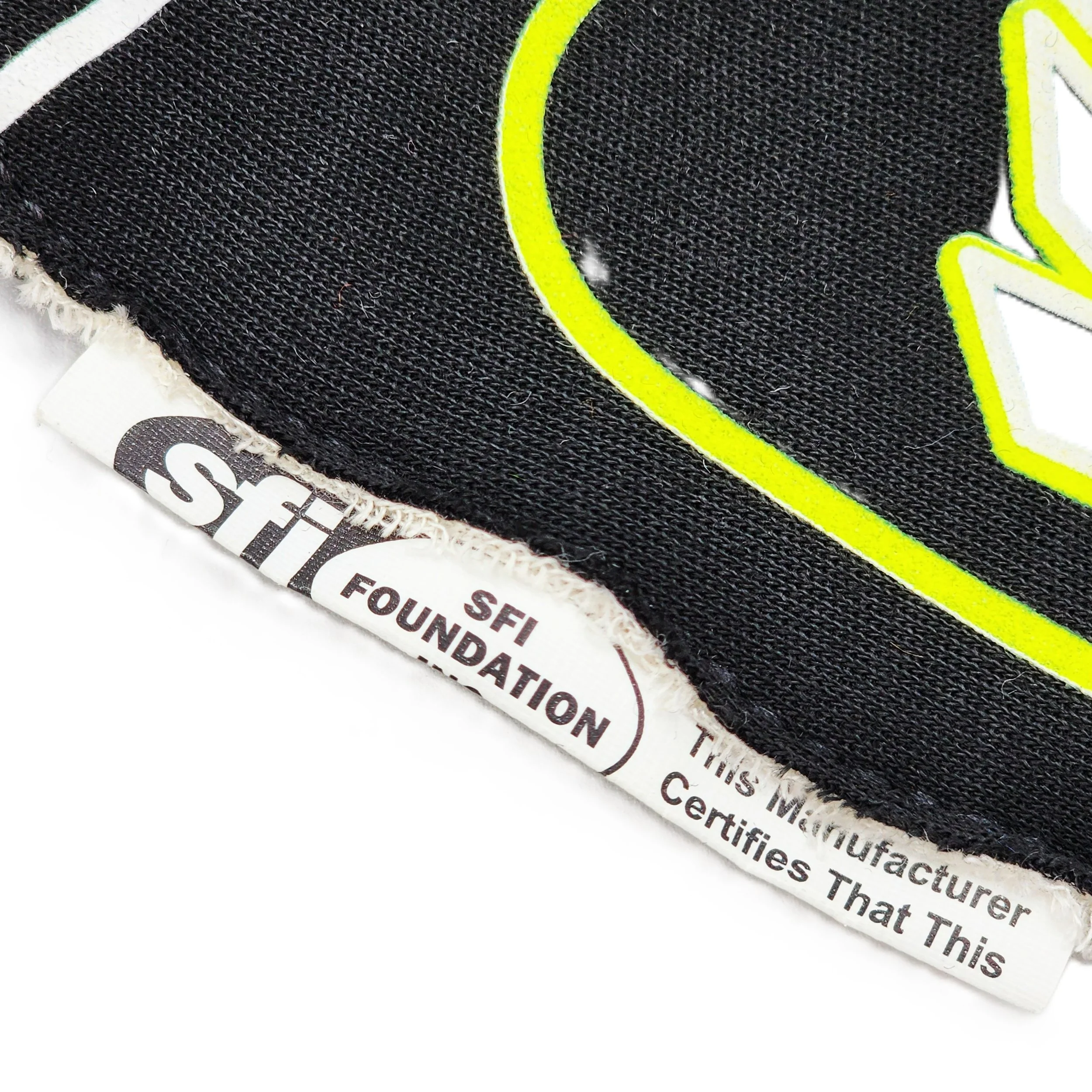 Detail of a SFI safety tag on a racing glove
