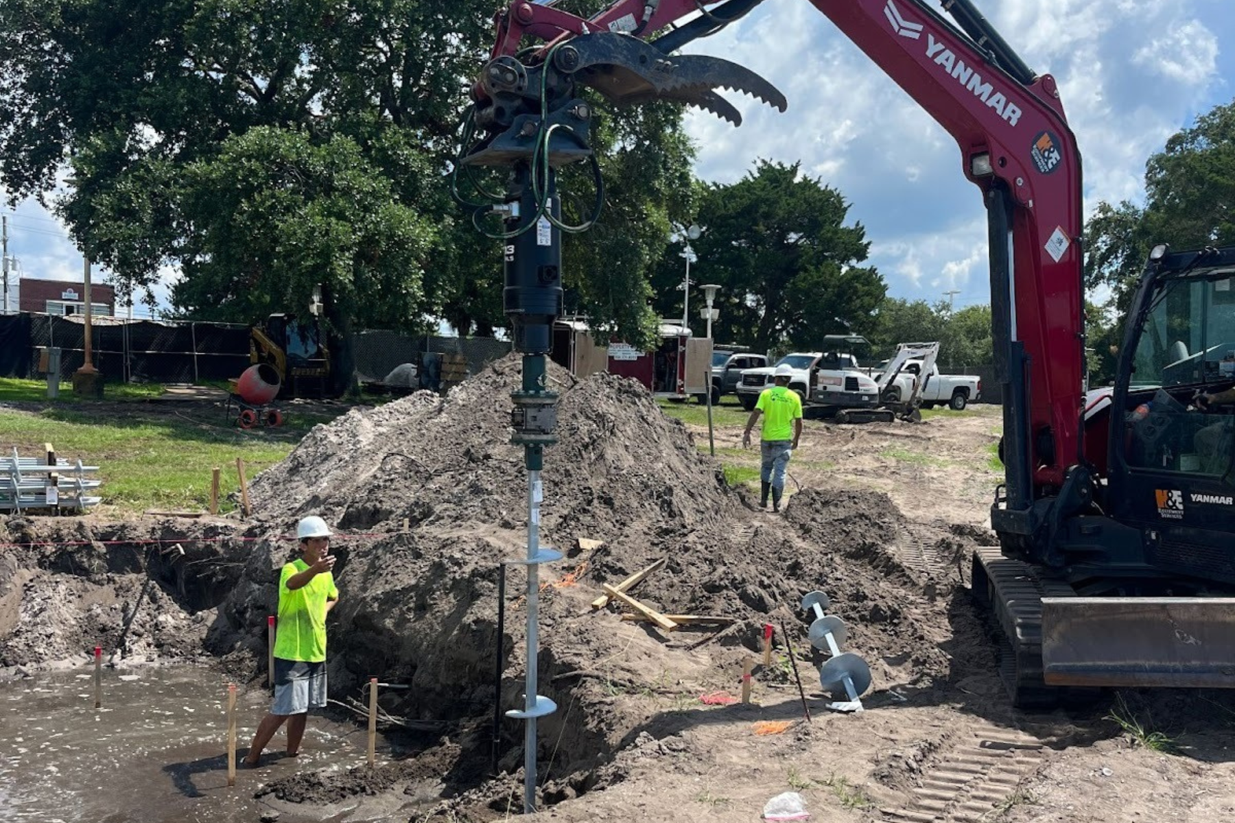Hydraulic torque motor advancing CHANCE helical anchor into coastal soil during Florida Panhandle seawall project