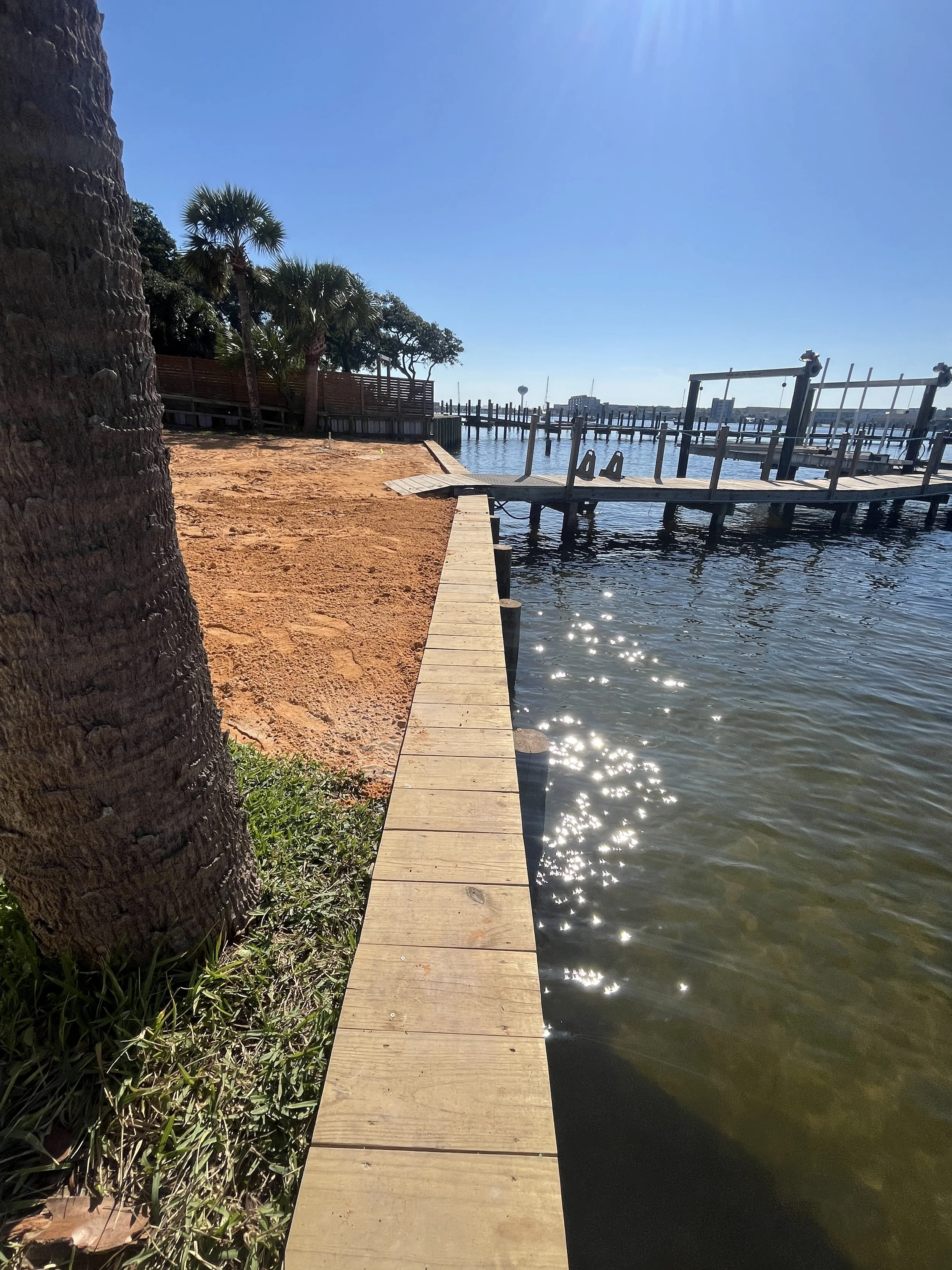 Completed helical tieback anchor seawall repair with new timber boardwalk cap Florida Panhandle waterfront