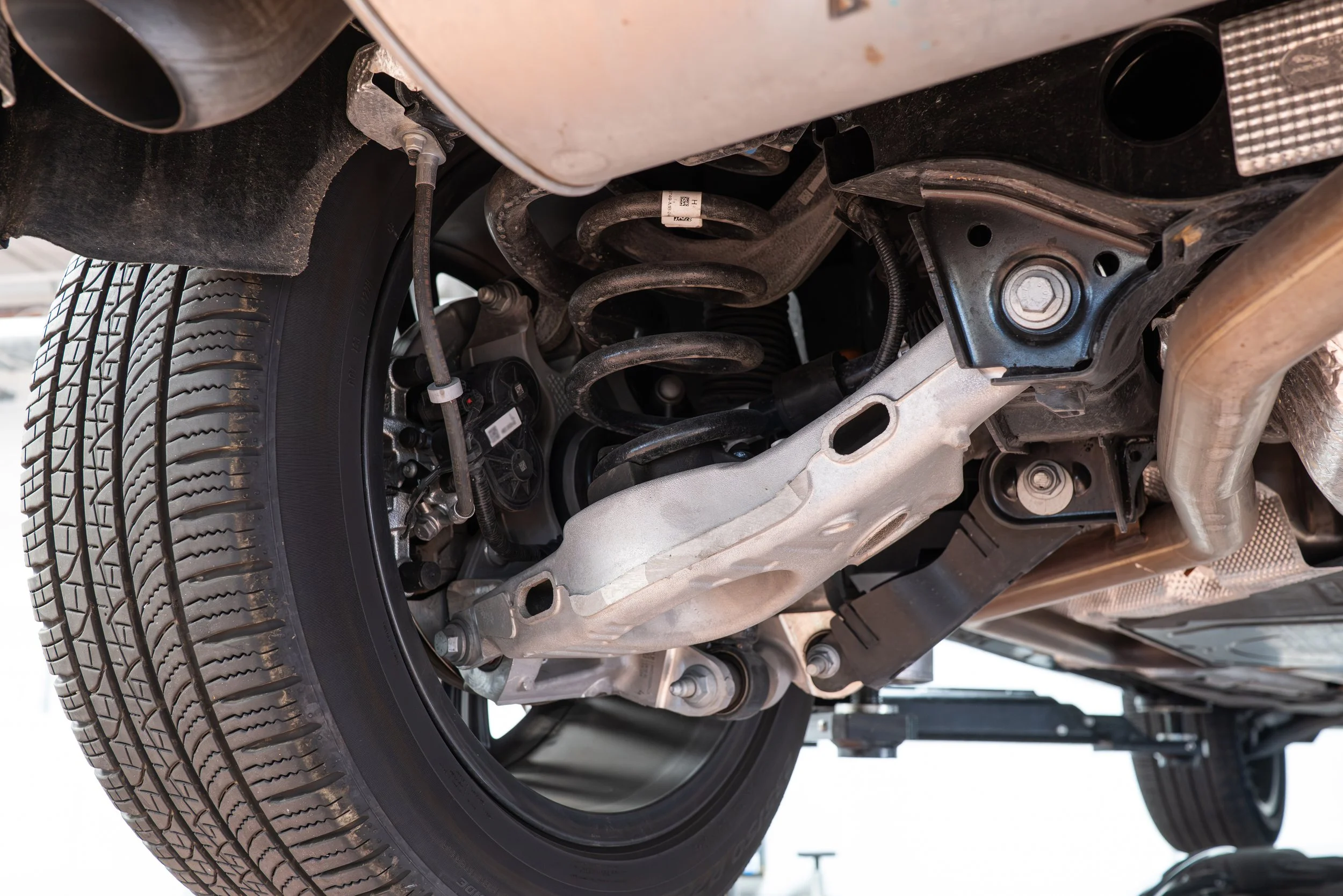 Underneath view of a car showing the tire and suspension