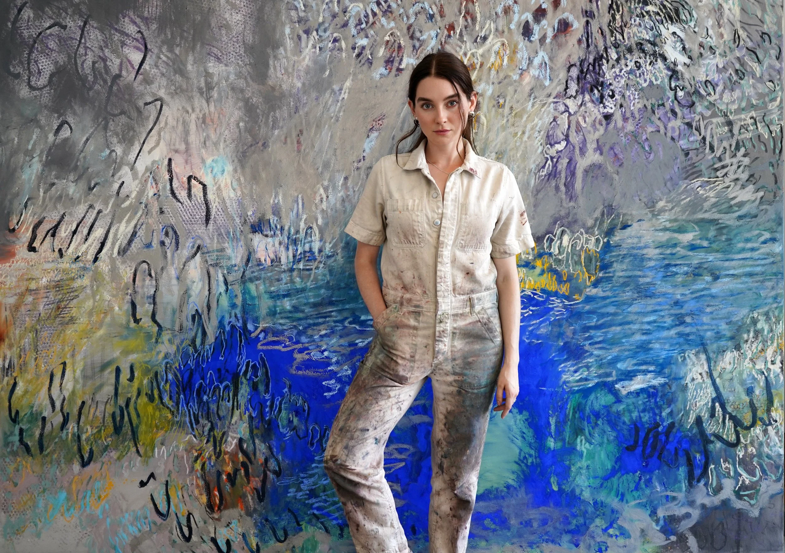 Sarah Martin-Nuss, contemporary artist and painter based in Brooklyn, standing in her studio in front of her painting Echoing and Dissolving, which was included in the Pace Gallery Los Angeles group exhibition Land Marks.