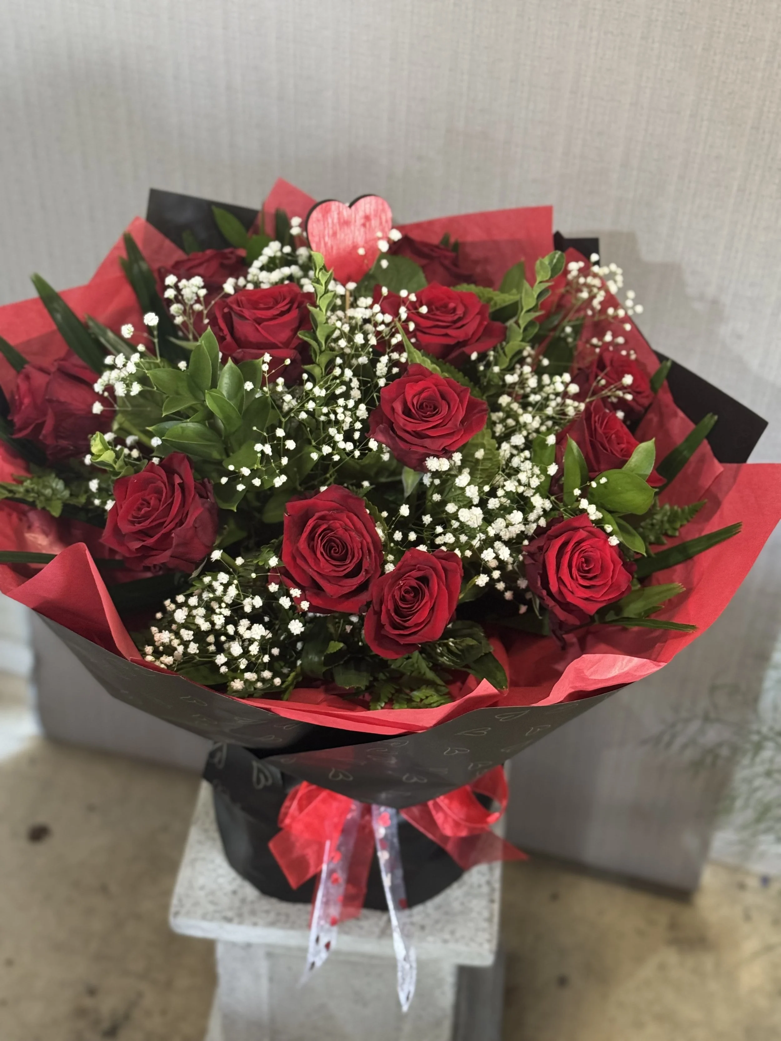 12 Premium Red Roses styled in a water Vox