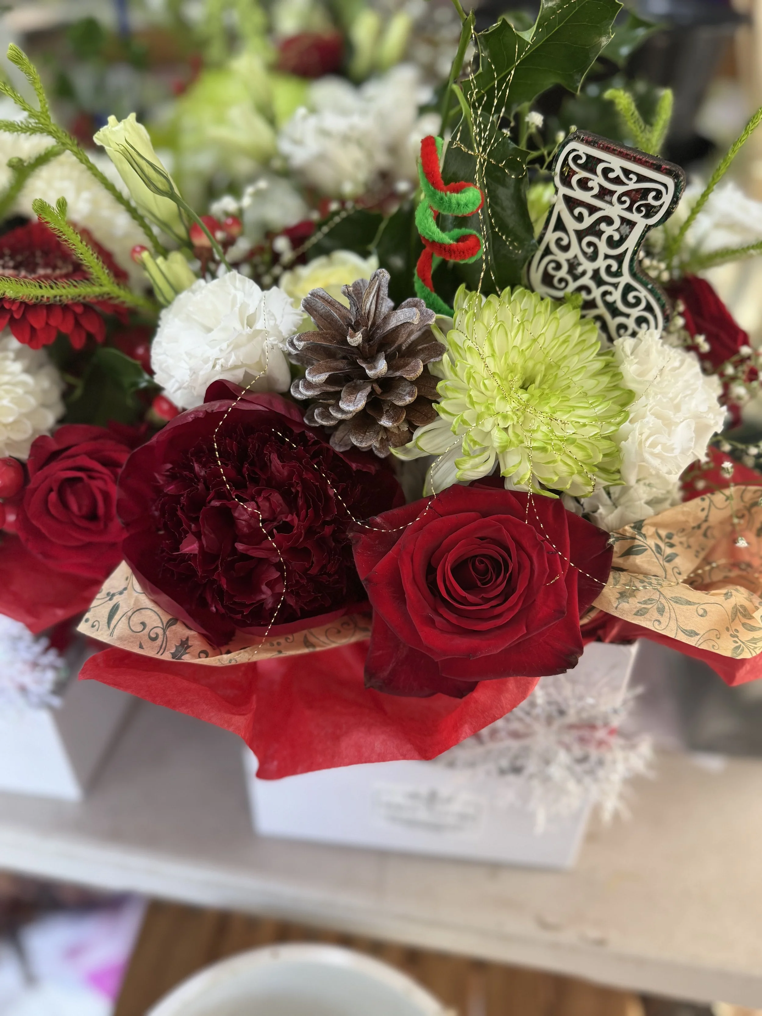 Christmas posy box with red roses and white seasonal flowers, handcrafted by an Auckland florist delivering to Takanini, Manurewa and Papakura.jpeg