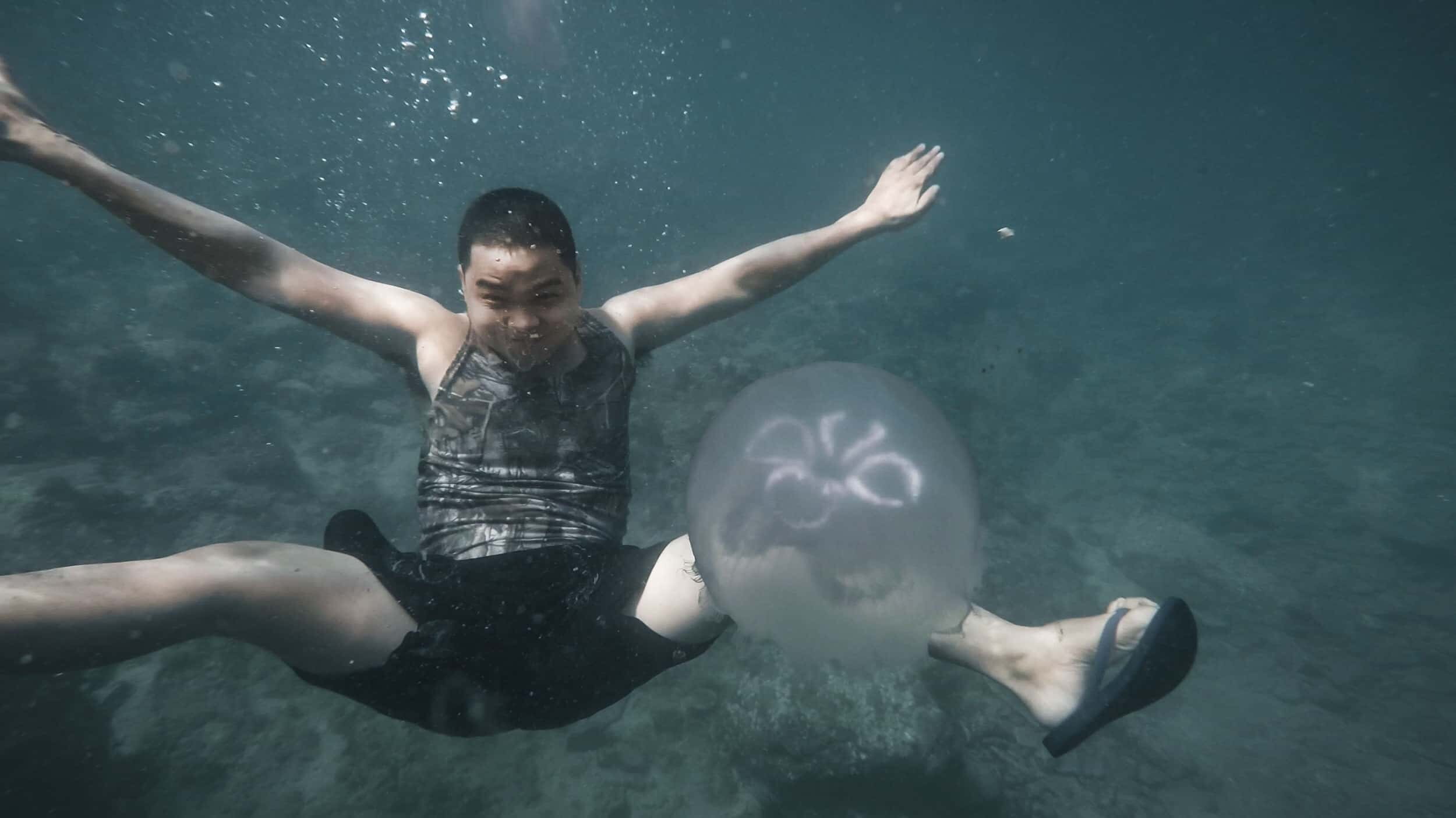 Underwater Photo with Jellyfish in Five Fingers