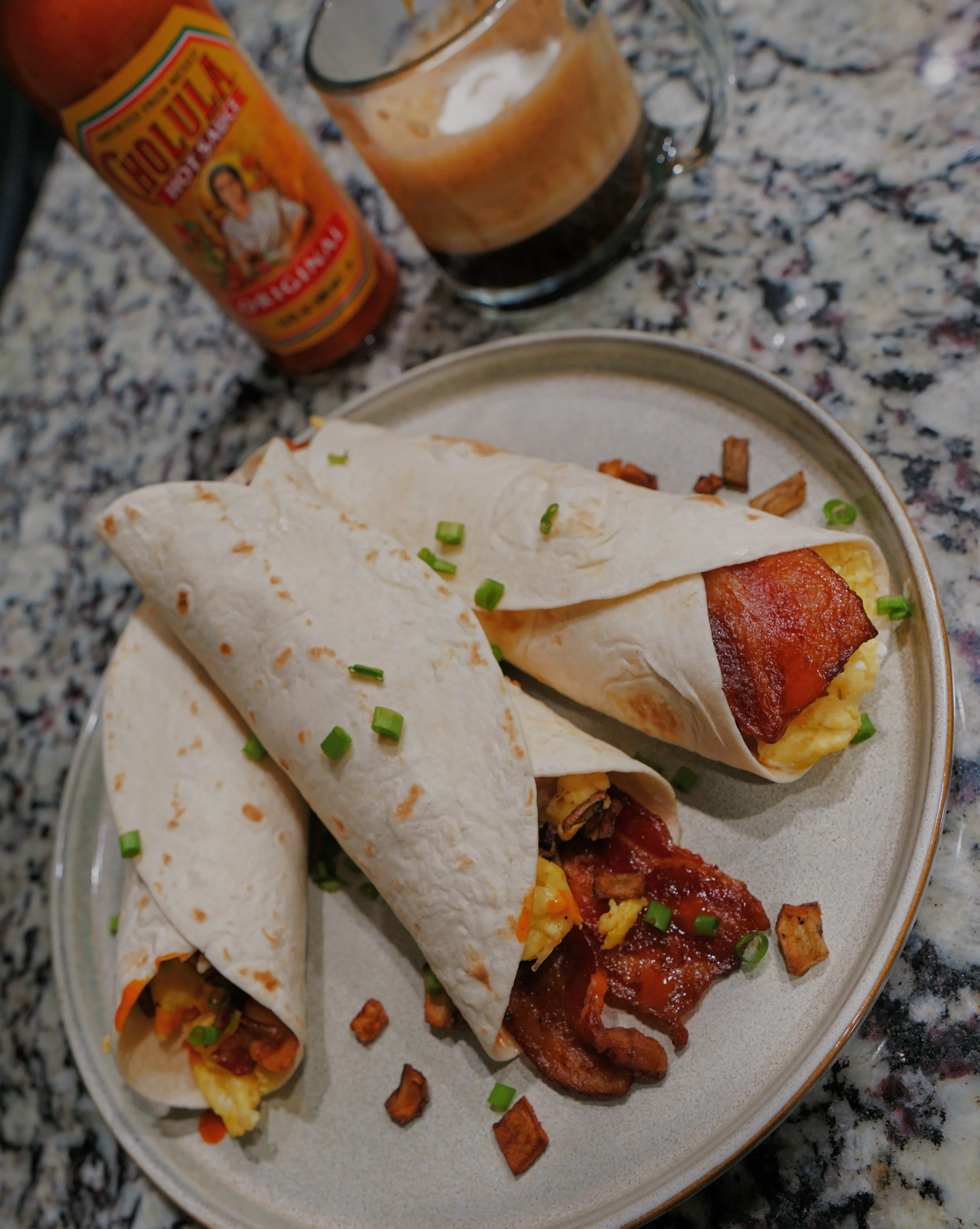 Bacon breakfast burrito made with eggs, shredded cheese, potato, and a carb balance tortilla for a high-protein, macro-friendly breakfast