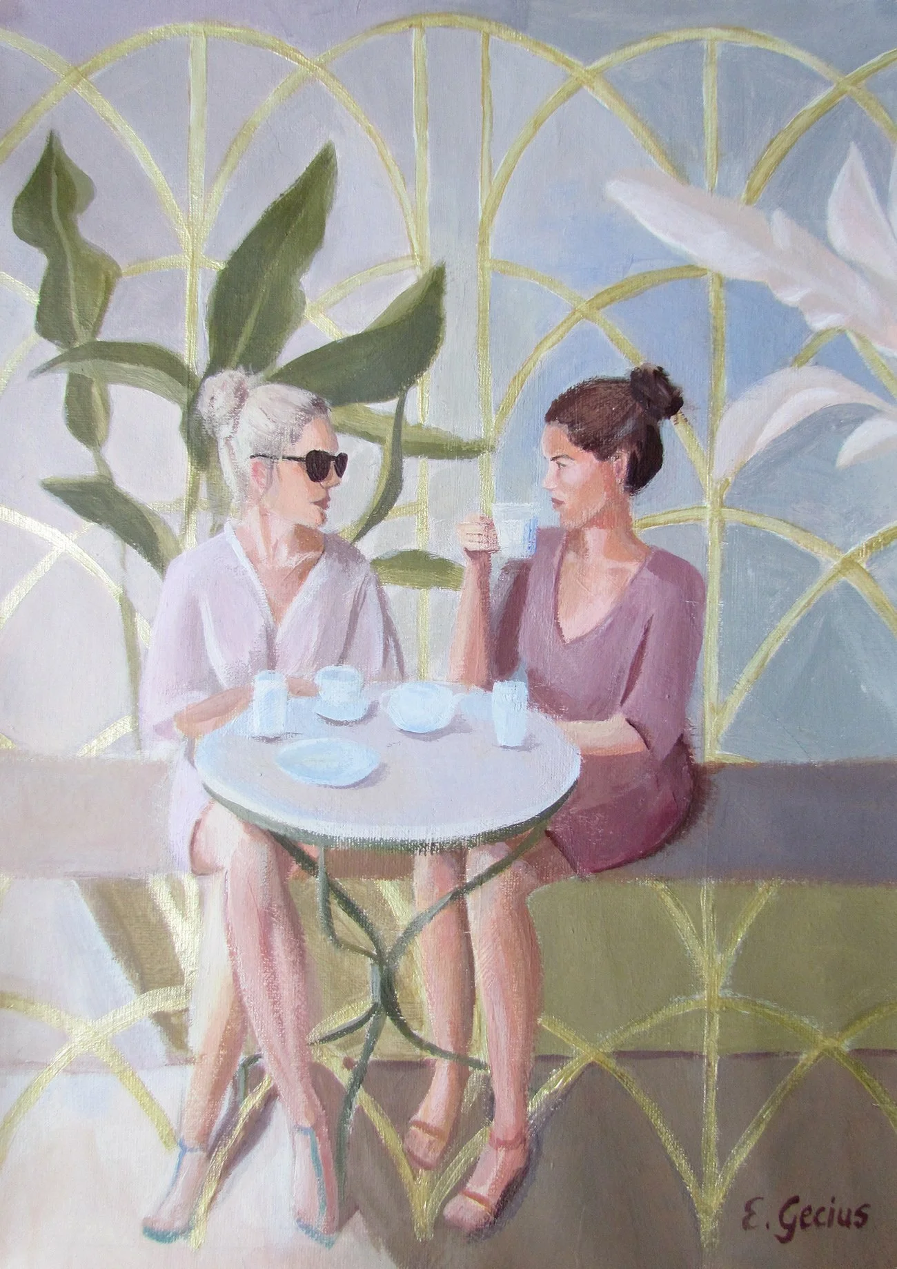 Zwei Frauen sitzen an einem runden Tisch, trinken Wasser und unterhalten sich. Im Hintergrund eine Pflanzenwand mit großen grünen Blättern. Eine Frau trägt Sonnenbrille und hat graue Haare, die andere hat braune Haare in einem Dutt.
