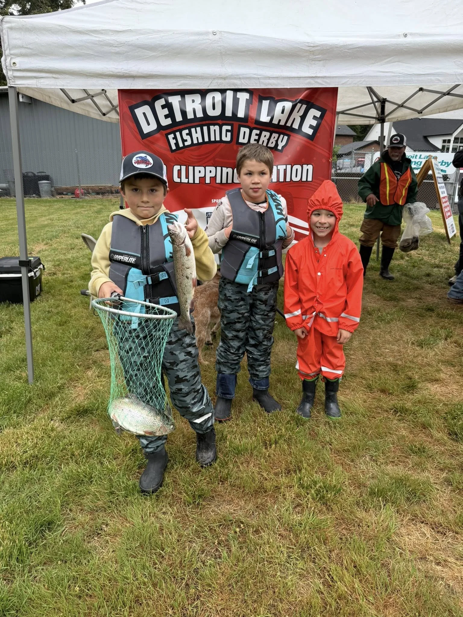 Boys showing their daily catches of Trout