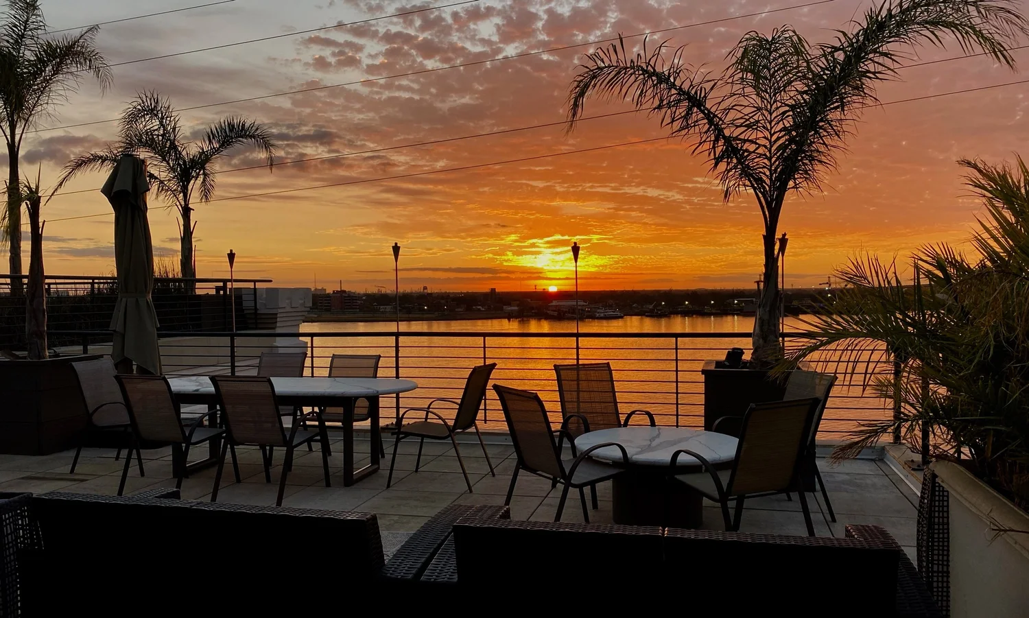 Sunset over the Mississippi River from the penthouse dining terrace in the French Quarter