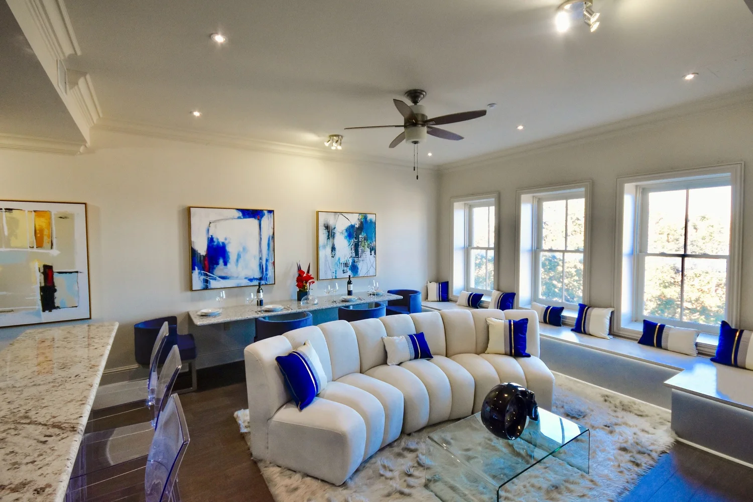 Bright living room with tall windows in the 1-bedroom pied-a-terre at Jax Brewery, French Quarter