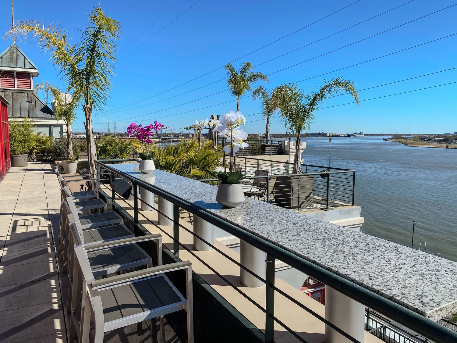 Riverfront terrace with bar seating overlooking the Mississippi River at Jax Brewery
