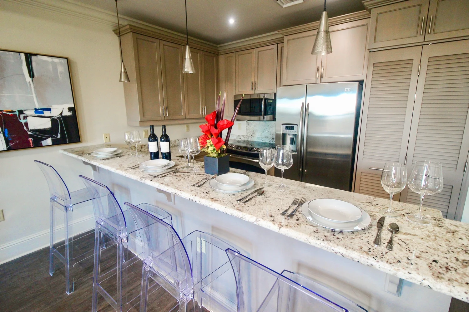 Kitchen with granite island and bar seating in the Jax Brewery 1-bedroom condo