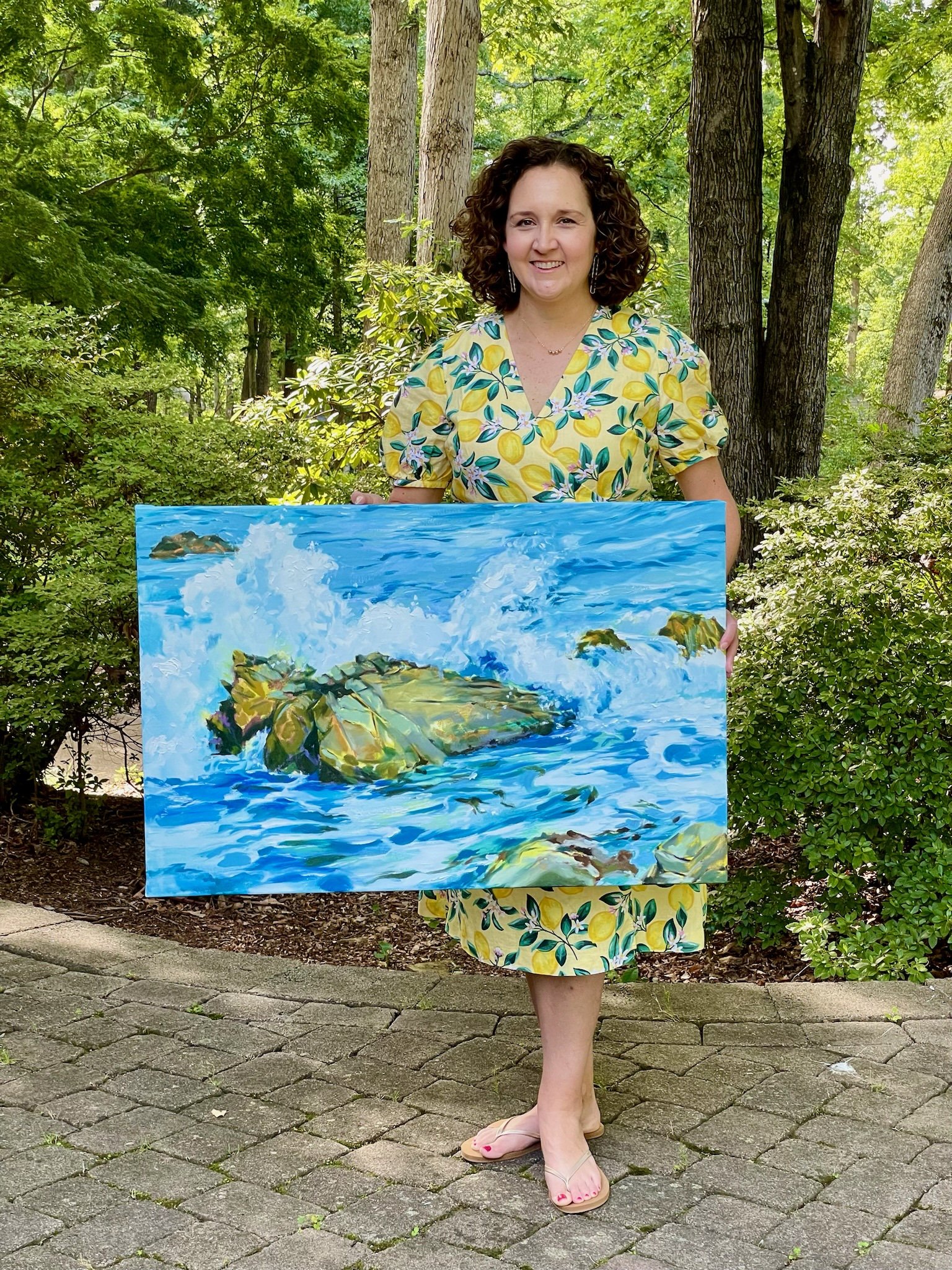 KatieHoldingWavePaintings.jpeg