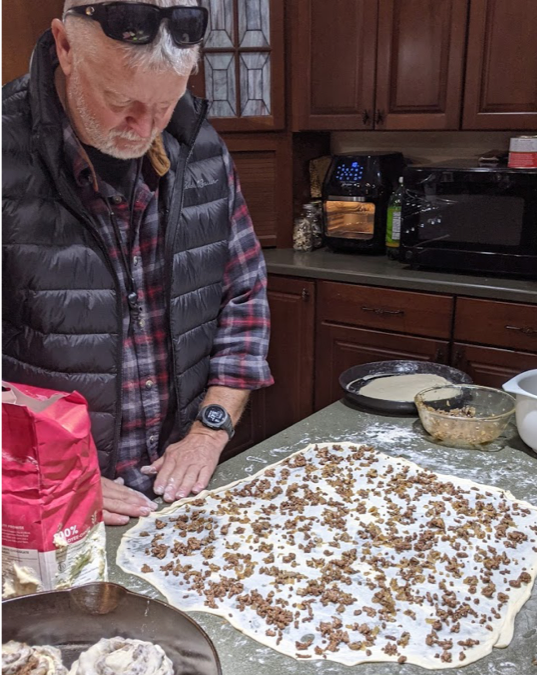 Spreading the meat and mushroom mixture across the pastry and trying our best to roll it up