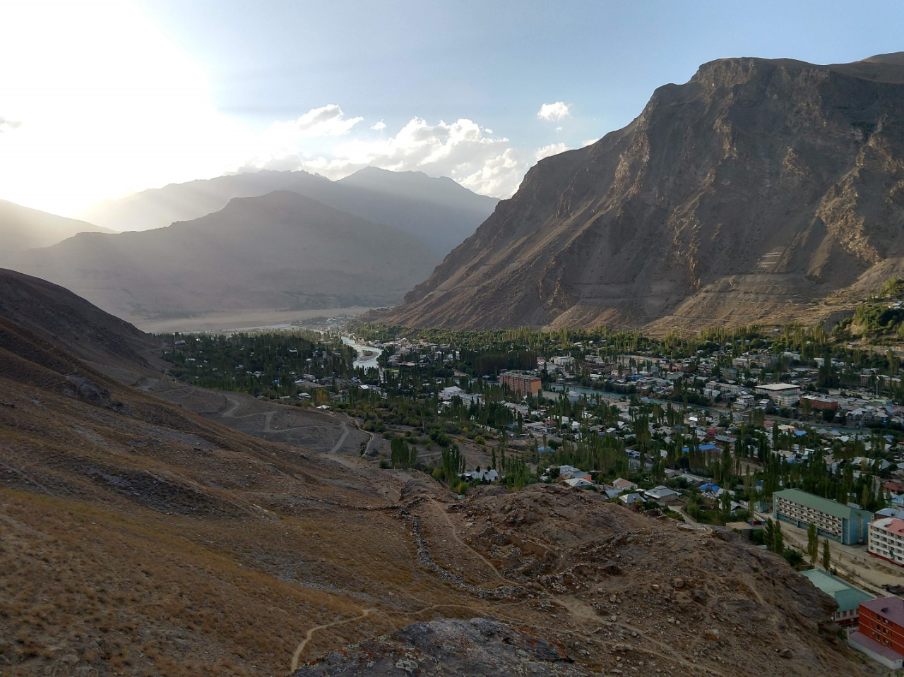 Looking down on the city of Khorugh, with Afghanistan in the background. Khorugh is the regional capital of Gorno-Badakhshan Autonomous Province and a political, economic, and cultural center for Pamiri people. Institutions funded by the Aga-Khan Development Network employ and provide services for many residents of the city and region. The Aga-Khan is the spiritual leader of the global Shia Ismaili Muslim community, adherents of which include most Pamiris.