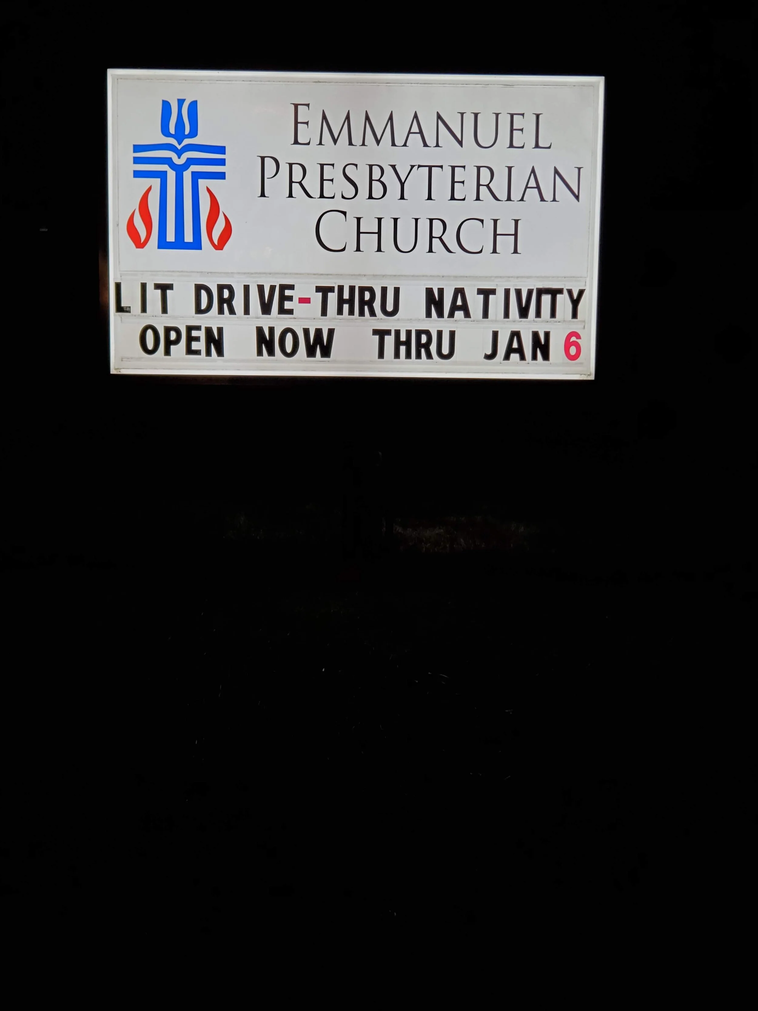 Sign for Emmanuel Presbyterian Church announcing a lit drive-thru nativity open now through January 6.