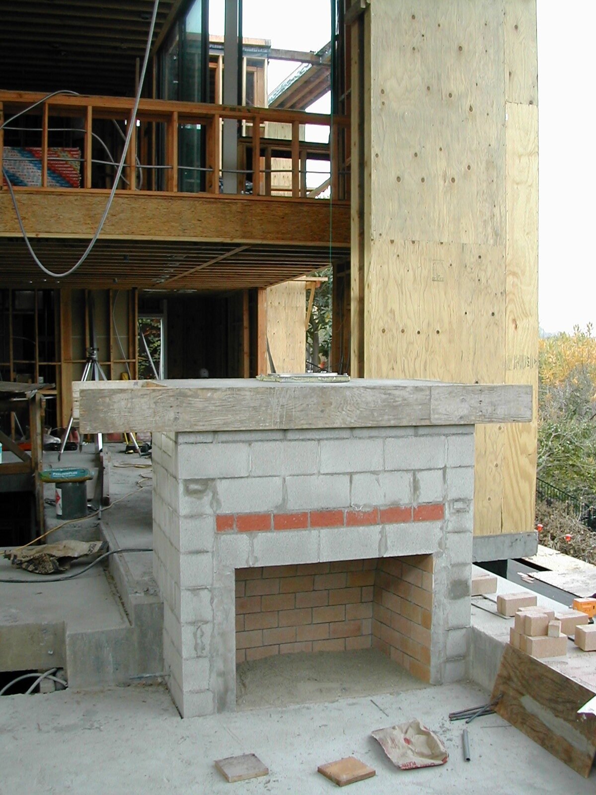  It seems difficult to compete with the simple economics of prefabricated fireplaces unless you have a memory of the real thing. In calculating the budget, we earmarked the funds for a brick and concrete fireplace, but as we progressed through founda