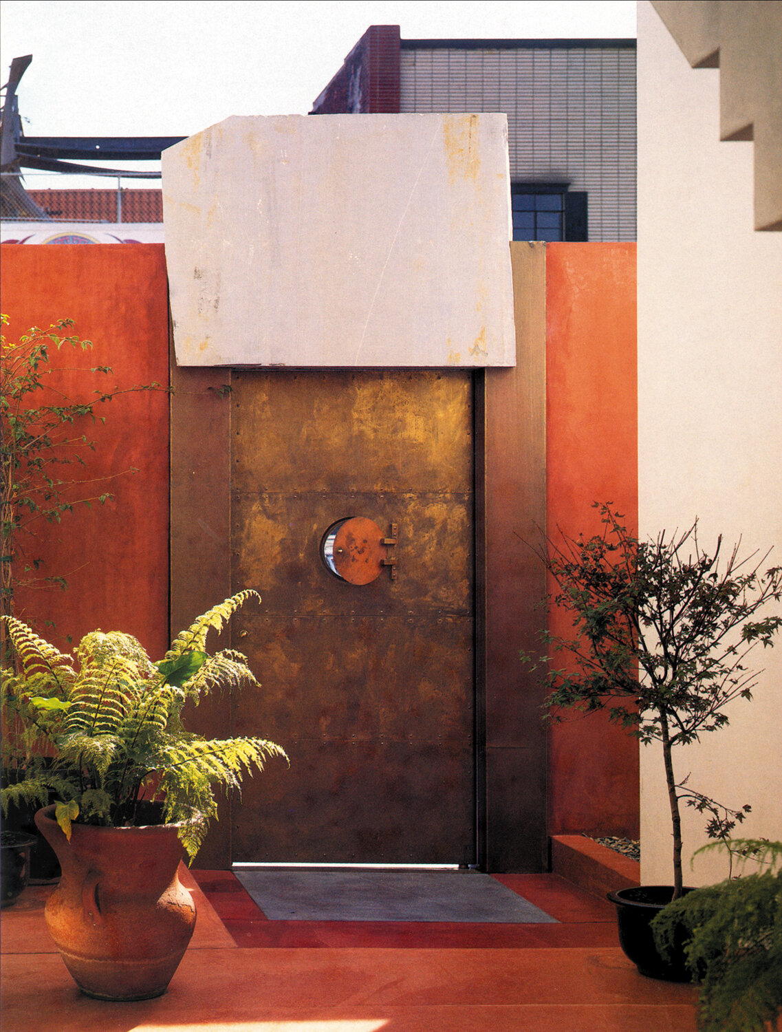Bronze gate and quarry hewn solid stone lintel.