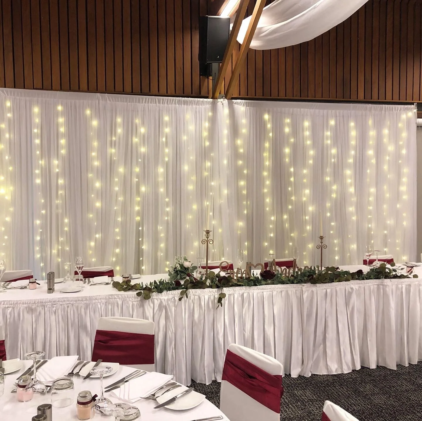 White chiffon material backdrop with waterfall fairy lights.jpeg