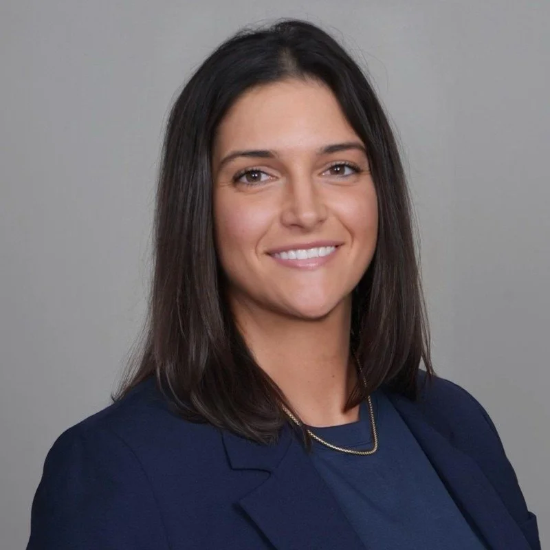 Brown haired white woman with navy balzer