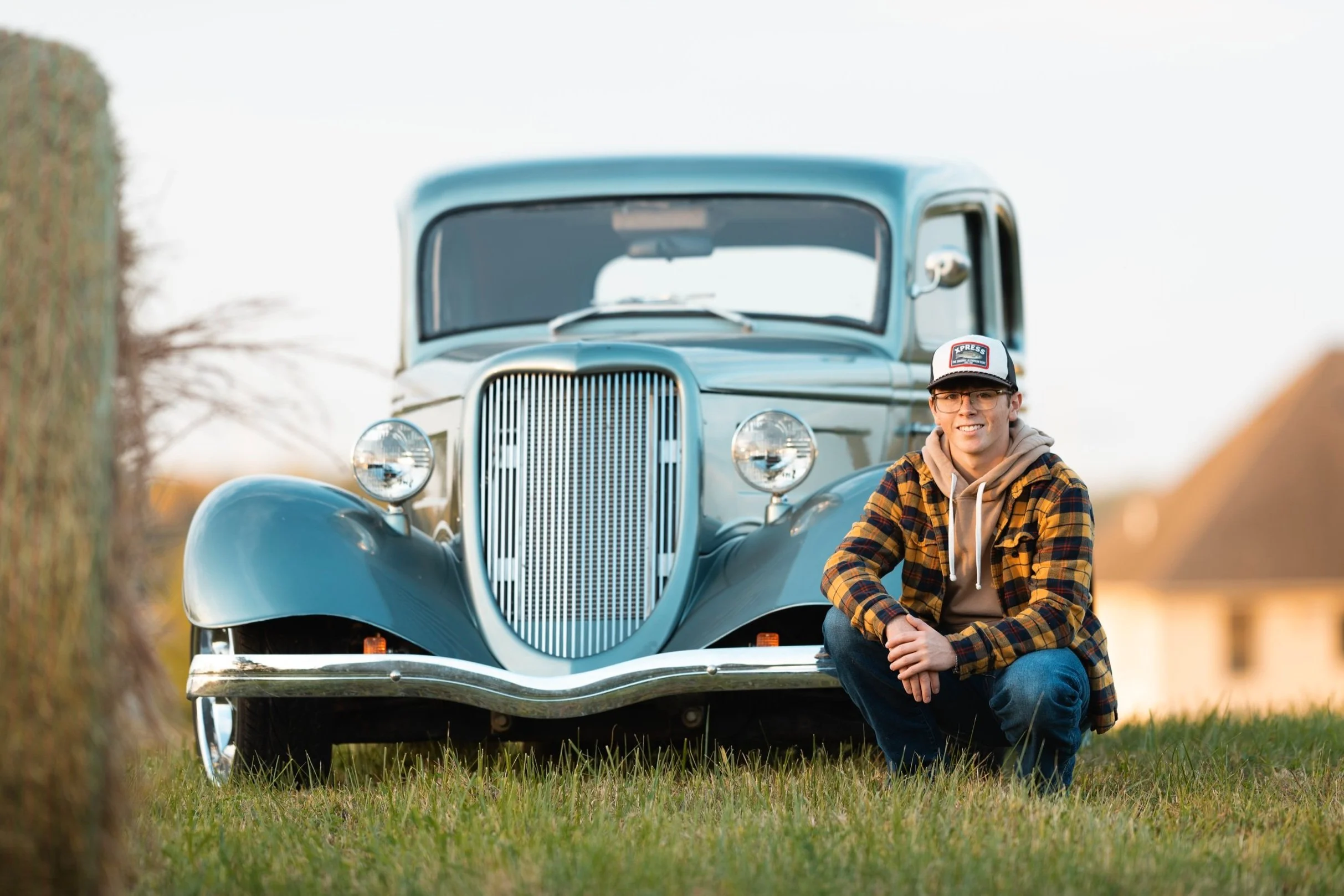 Victorville California Senior Photographer in Marion Illinois With Antique Car, Haybale, and Senior boy in Flannel, ball cap, and jeans