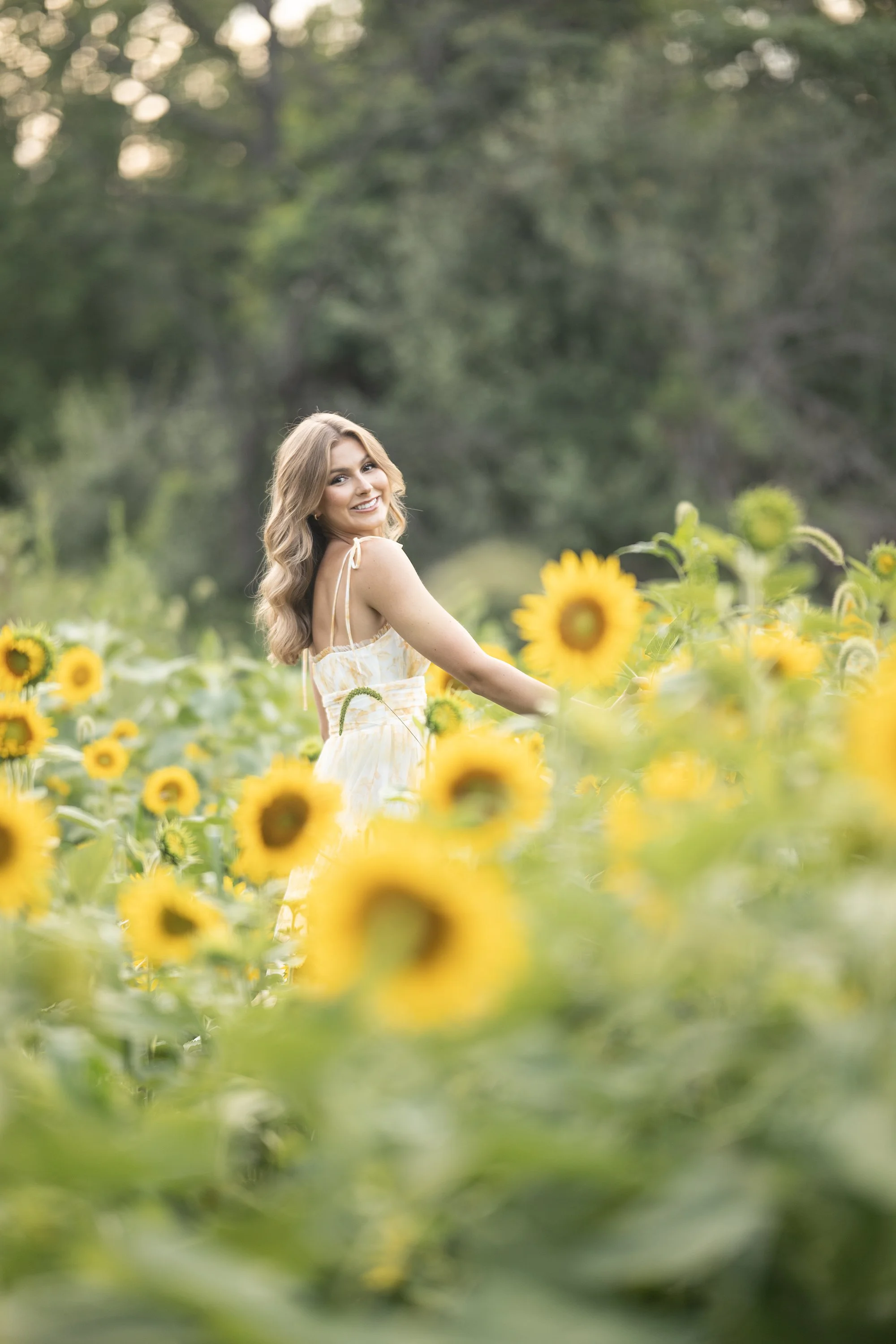 Beautiful Golden hour Sunflower field with Senior Girl smiling in field of sunflowers Victorville California
