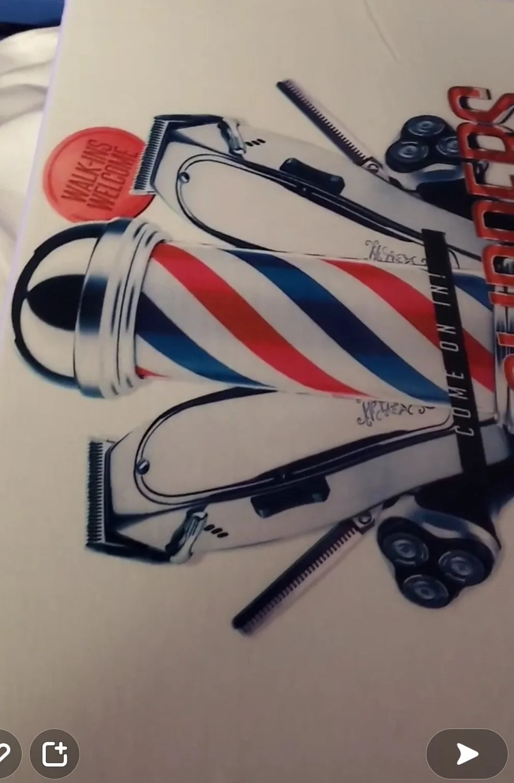A colorful barber pole with red, white, and blue stripes, along with barber tools such as scissors, razors, and combs arranged around it.