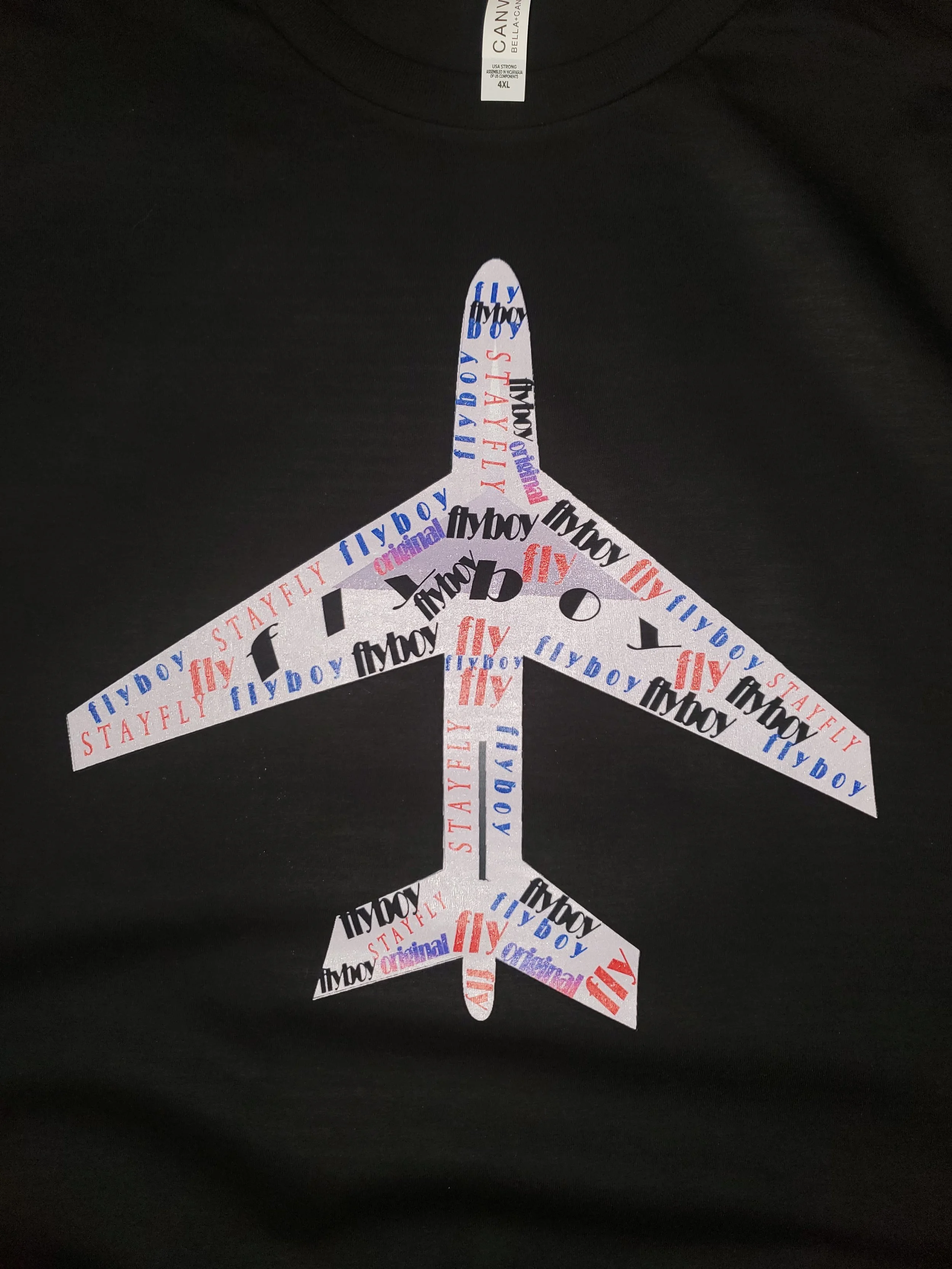 Black T-shirt featuring a peace sign made of the words 'fly,' 'stayfly,' 'original,' and 'flyboy' in various colors.